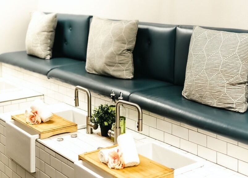 Luxurious nail stations at La Belle Vie Salon and Spa, Pleasant Grove, Utah, US, featuring plush seating and elegant decor.