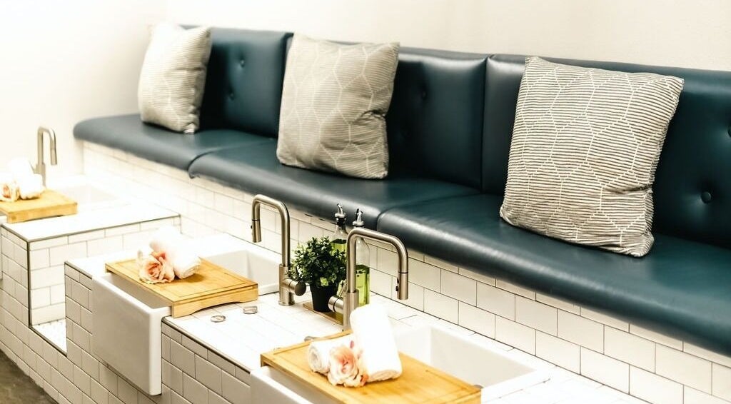 Luxurious nail stations at La Belle Vie Salon and Spa, Pleasant Grove, Utah, US, featuring plush seating and elegant decor.