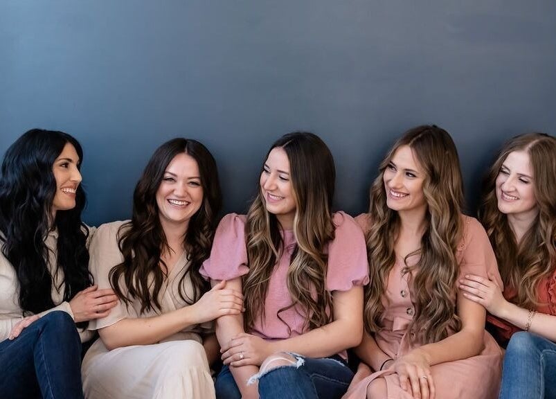 Group of women smiling and sitting together at La Belle Vie Salon and Spa, Pleasant Grove, Utah, US.