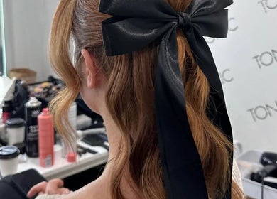Elegant ponytail with a black bow at Spring Racing Carnival Bookings - FITZROY POP UP, Fitzroy, Victoria, AU.