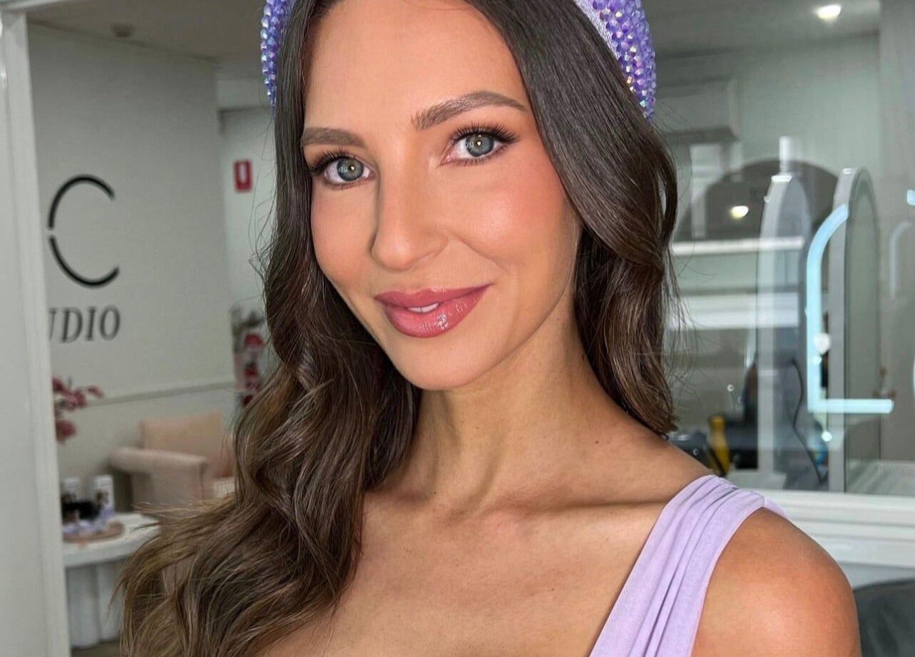 Smiling woman with styled hair at Spring Racing Carnival Bookings - PRAHRAN, Prahran, Victoria, AU.