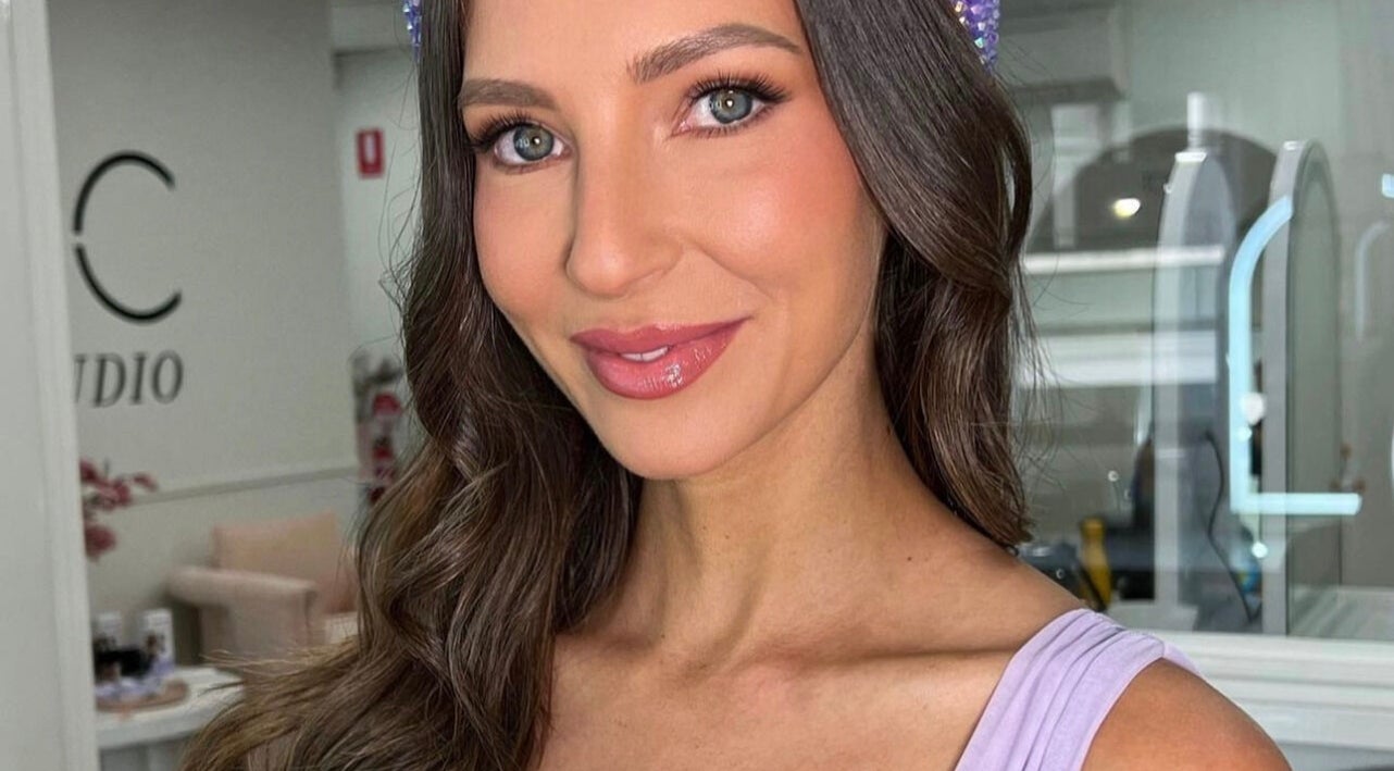 Smiling woman with styled hair at Spring Racing Carnival Bookings - PRAHRAN, Prahran, Victoria, AU.