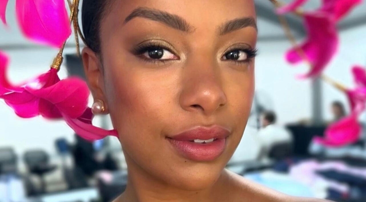 Woman with stylish pink floral headpiece at Spring Racing Carnival Bookings - PRAHRAN, Prahran, Victoria, AU.