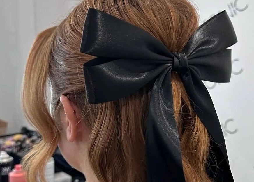 Chic hairstyle with black bow at Spring Racing Carnival Bookings - PRAHRAN, Prahran, Victoria, AU.
