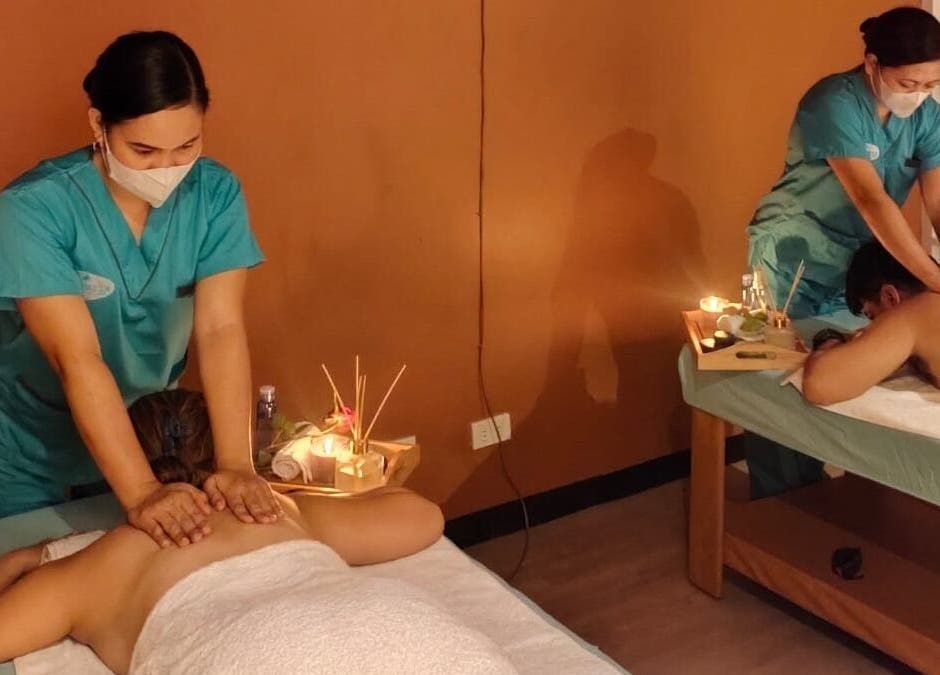 Two therapists at Turquesa Massage and Spa in Makati, Metro Manila, PH provide calming massage treatments.