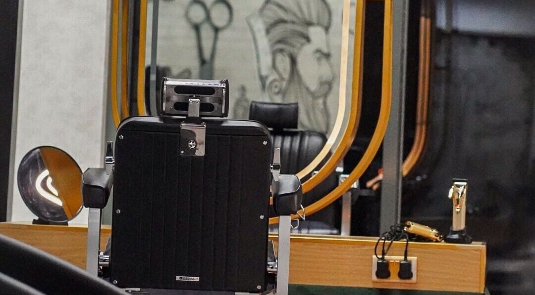 Elegant barber chair at Mr One Salon and Spa, Dubai, reflects luxury grooming in a modern setting.