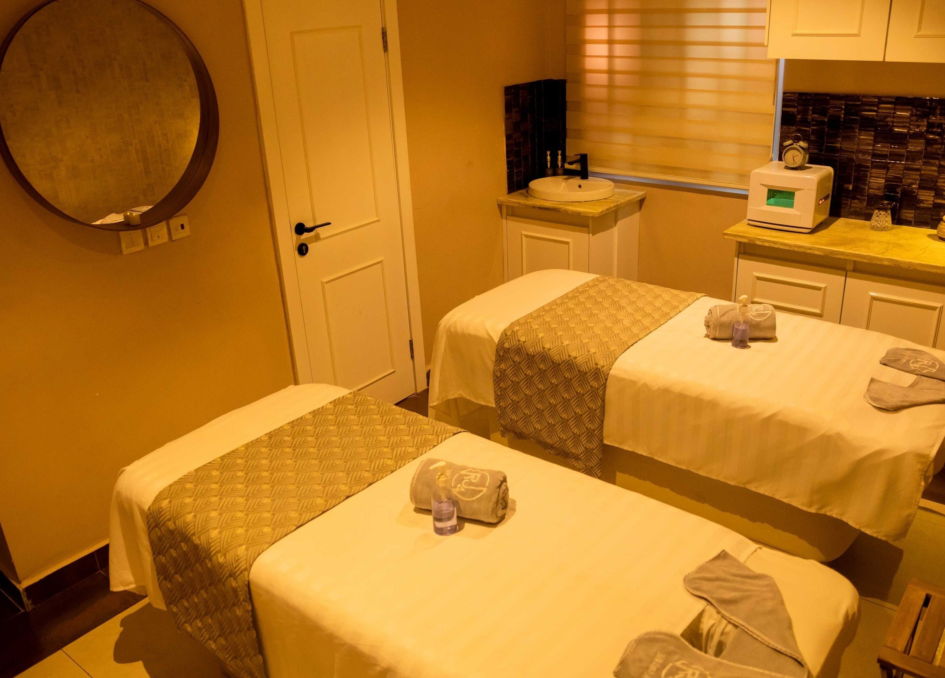 Massage room at The Medspa at Rj4 in Lagos, Lagos, NG, featuring twin tables and serene decor.