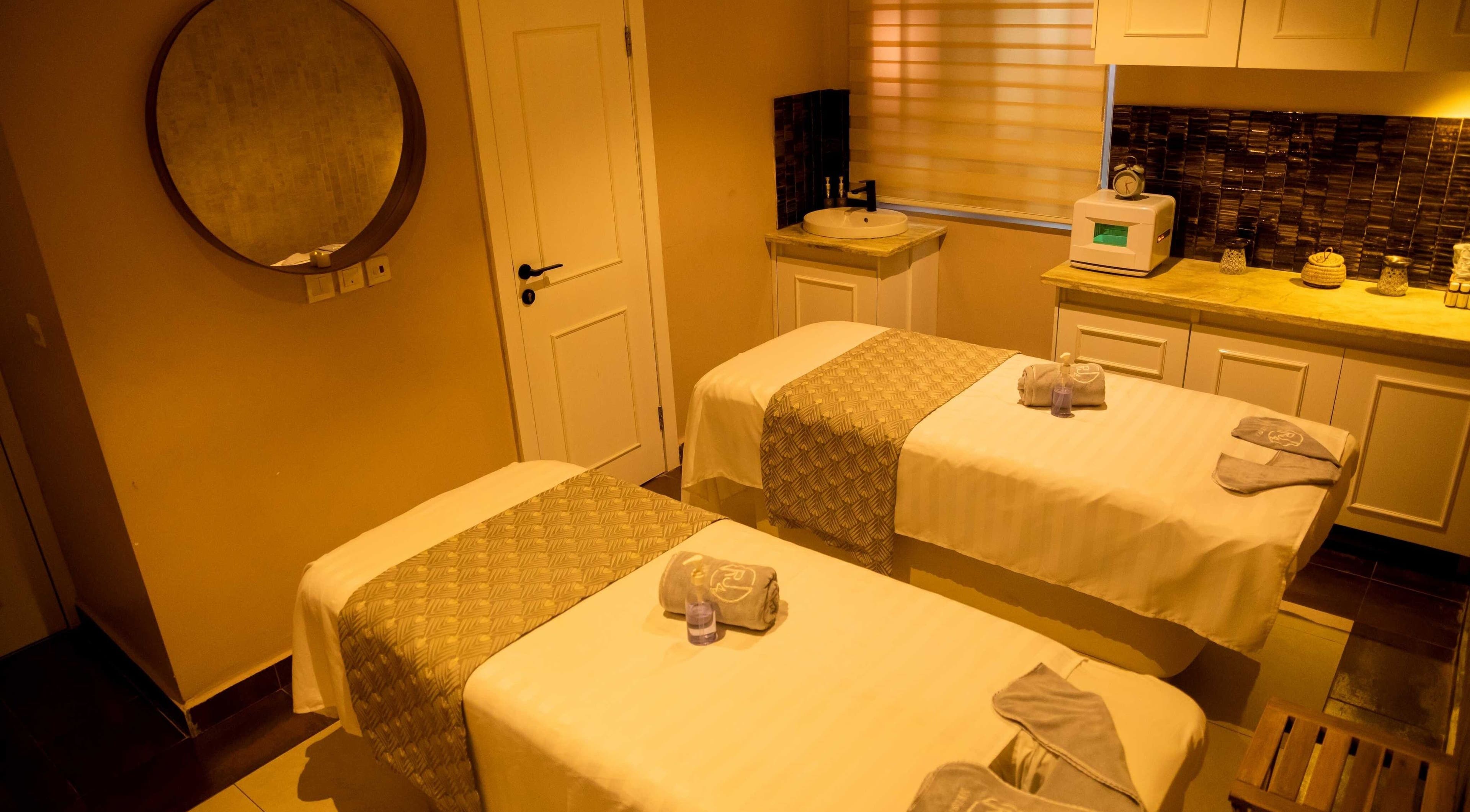 Massage room at The Medspa at Rj4 in Lagos, Lagos, NG, featuring twin tables and serene decor.