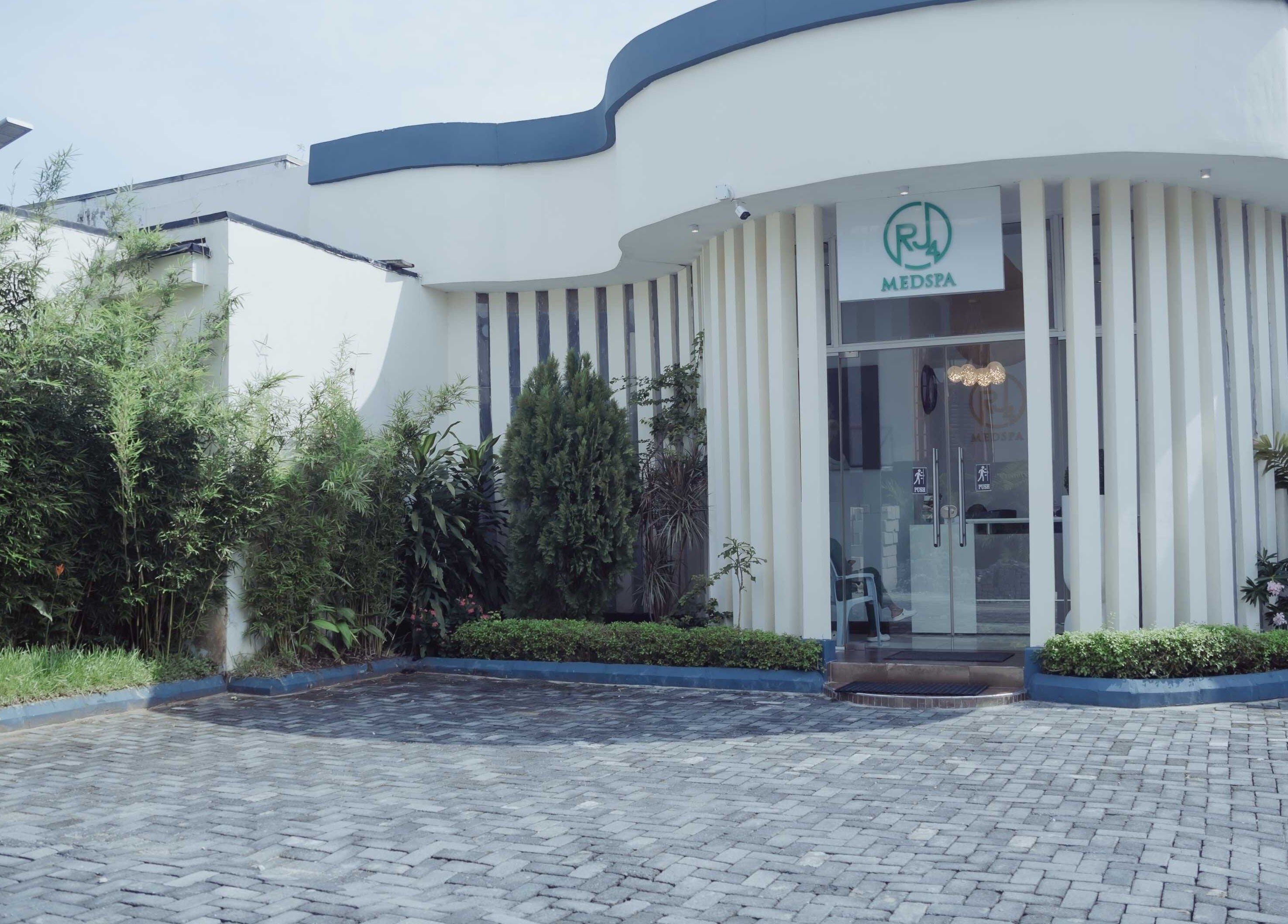 Elegant entrance of The Medspa at Rj4 with lush greenery in Lagos, Lagos, NG.