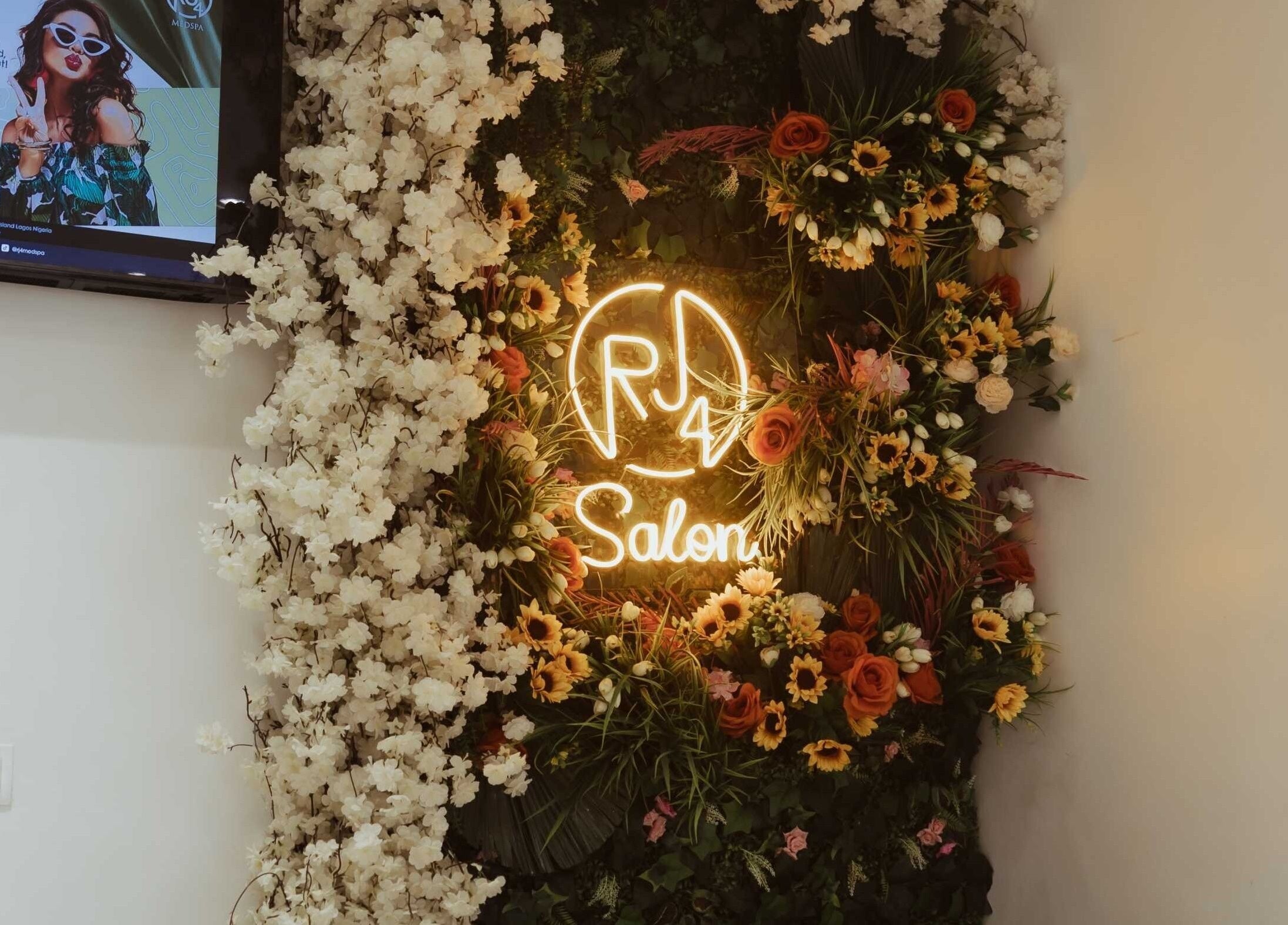 Vibrant floral display with neon sign at The Medspa at Rj4, Lagos, Lagos, NG, creating a welcoming ambiance.
