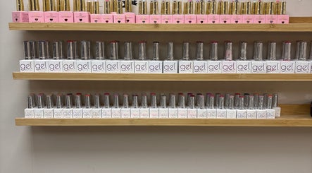 Gel nail polish display at Carly Mendes At Art House, Burnley, England, GB. Vibrant colors neatly arranged in rows.