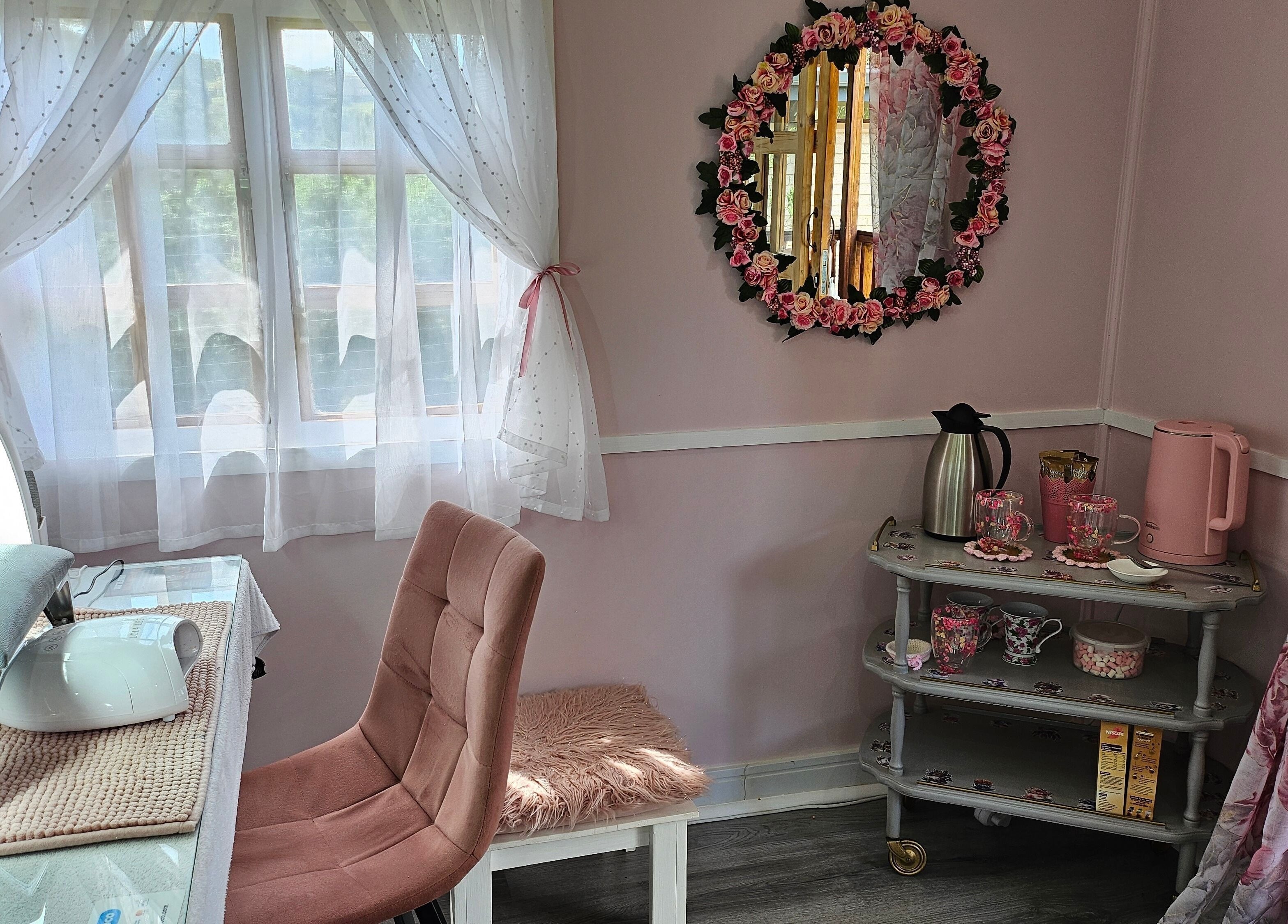 Cozy, chic corner at Tamlyn Artistry, Waterfall, Kwazulu-natal, ZA showcasing beauty essentials and floral decor.