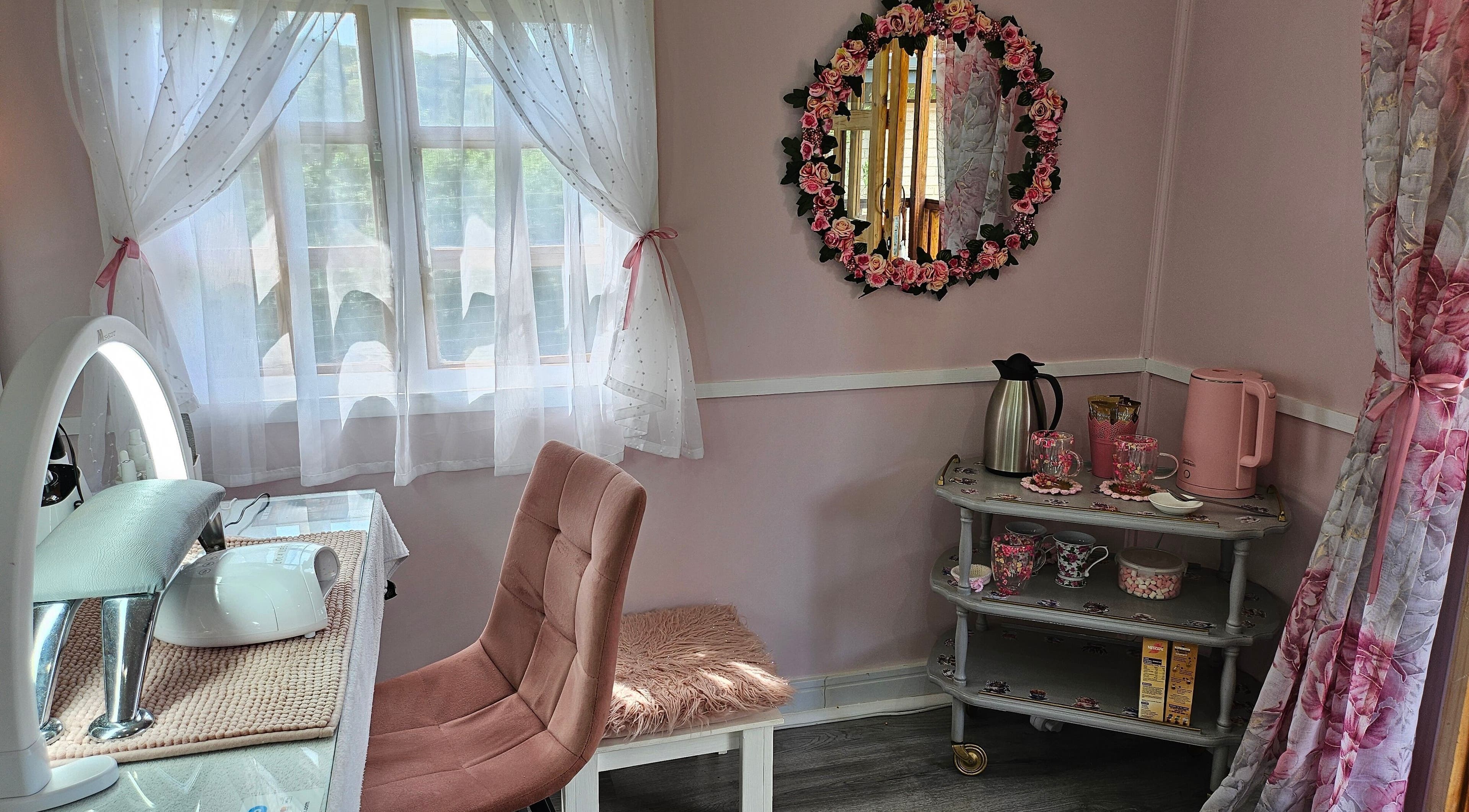 Cozy, chic corner at Tamlyn Artistry, Waterfall, Kwazulu-natal, ZA showcasing beauty essentials and floral decor.