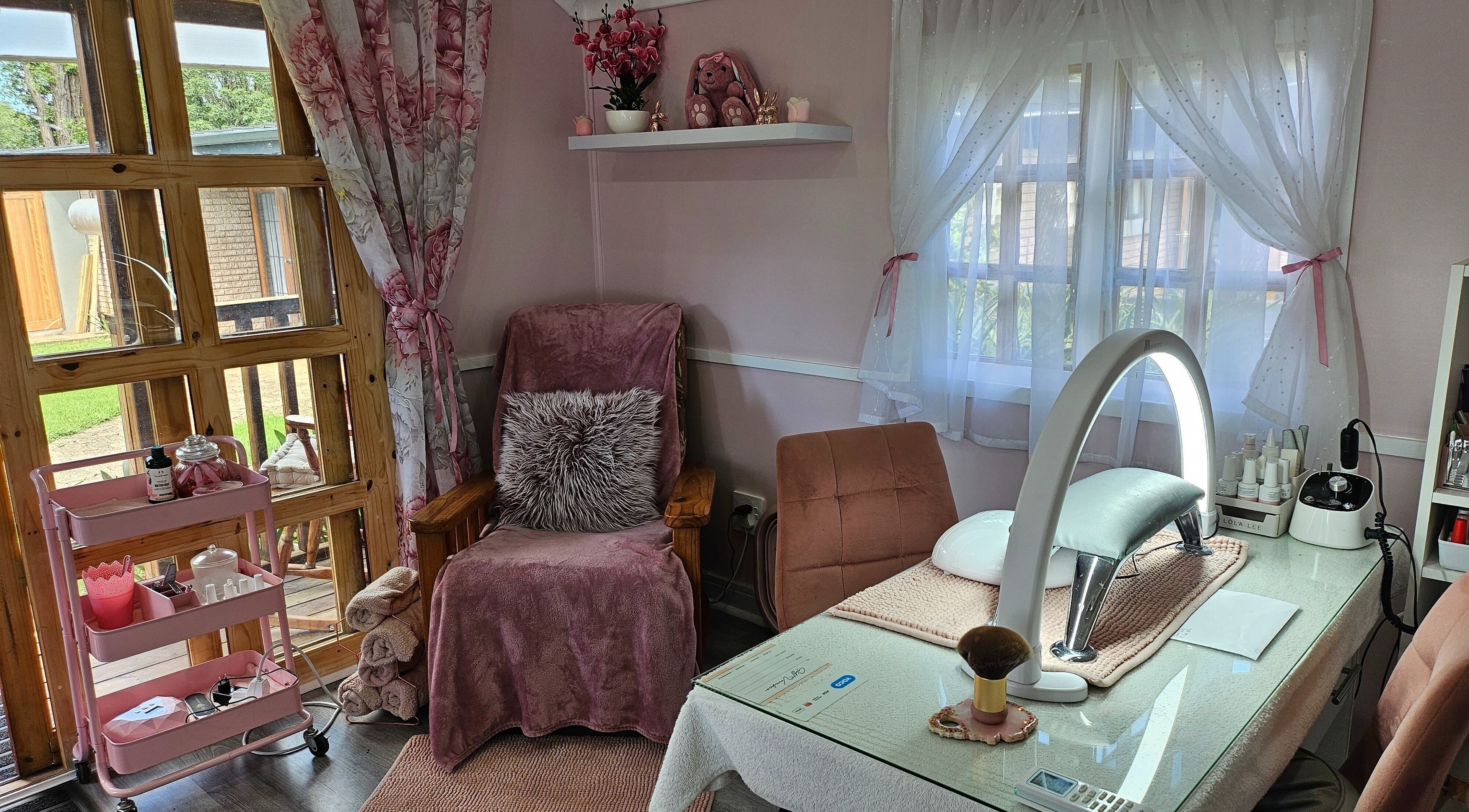 Cozy manicure setup at Tamlyn Artistry in Waterfall, Kwazulu-natal, ZA with plush pink decor.