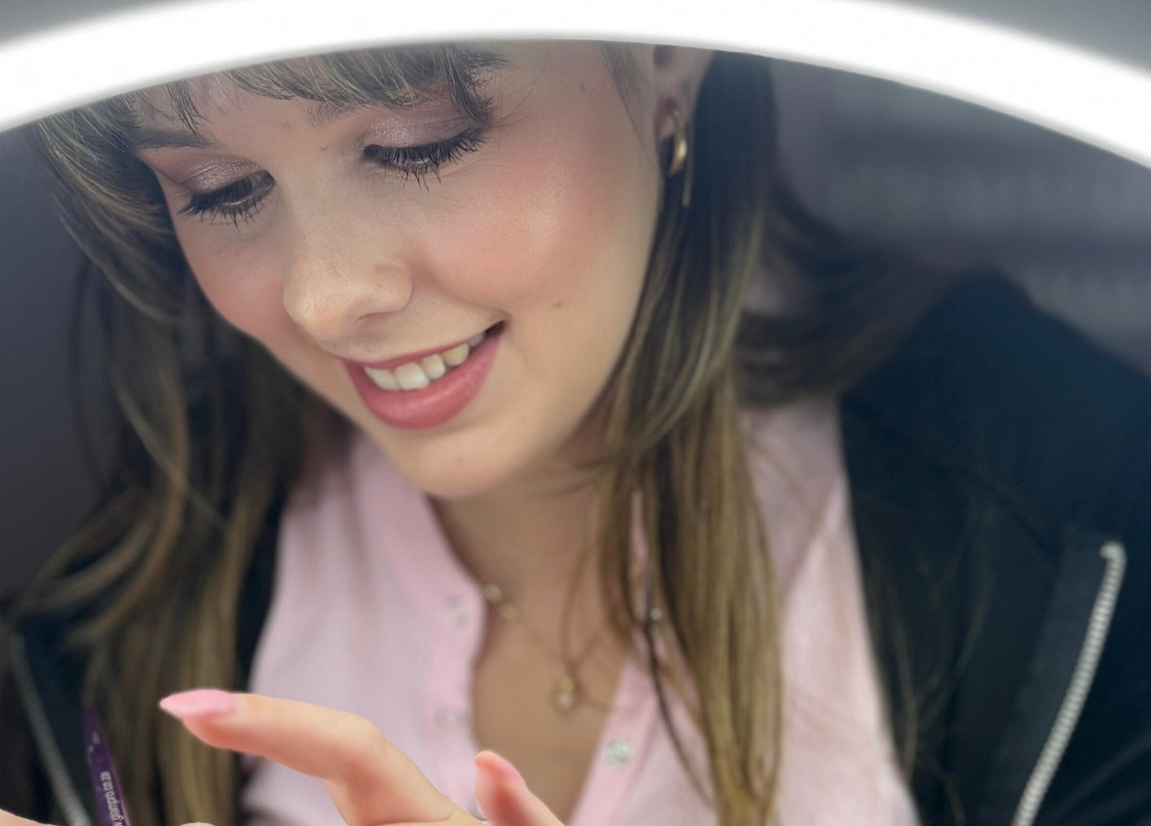 Smiling nail artist at Tamlyn Artistry, Waterfall, Kwazulu-natal, ZA, focused on precision nail work.