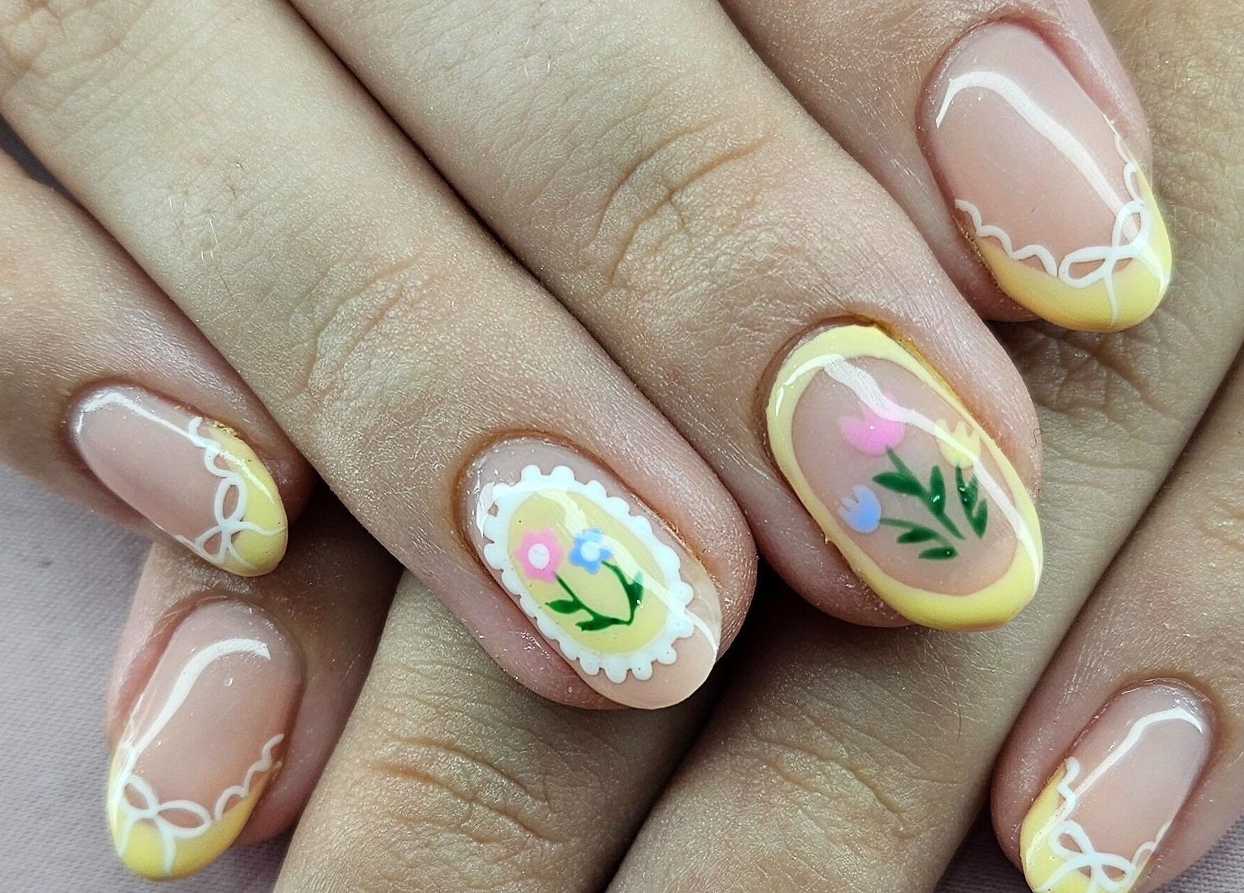 Floral nail art at Tamlyn Artistry, Waterfall, Kwazulu-natal, ZA exhibits intricate and colorful designs.