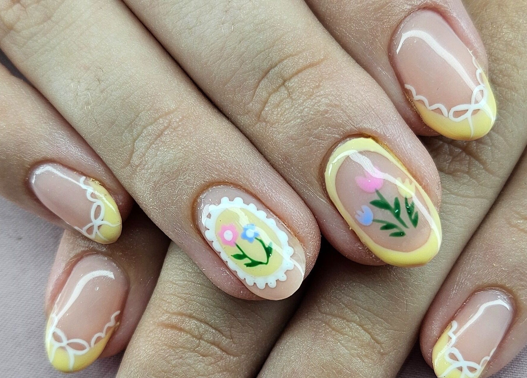 Floral nail art at Tamlyn Artistry, Waterfall, Kwazulu-natal, ZA exhibits intricate and colorful designs.