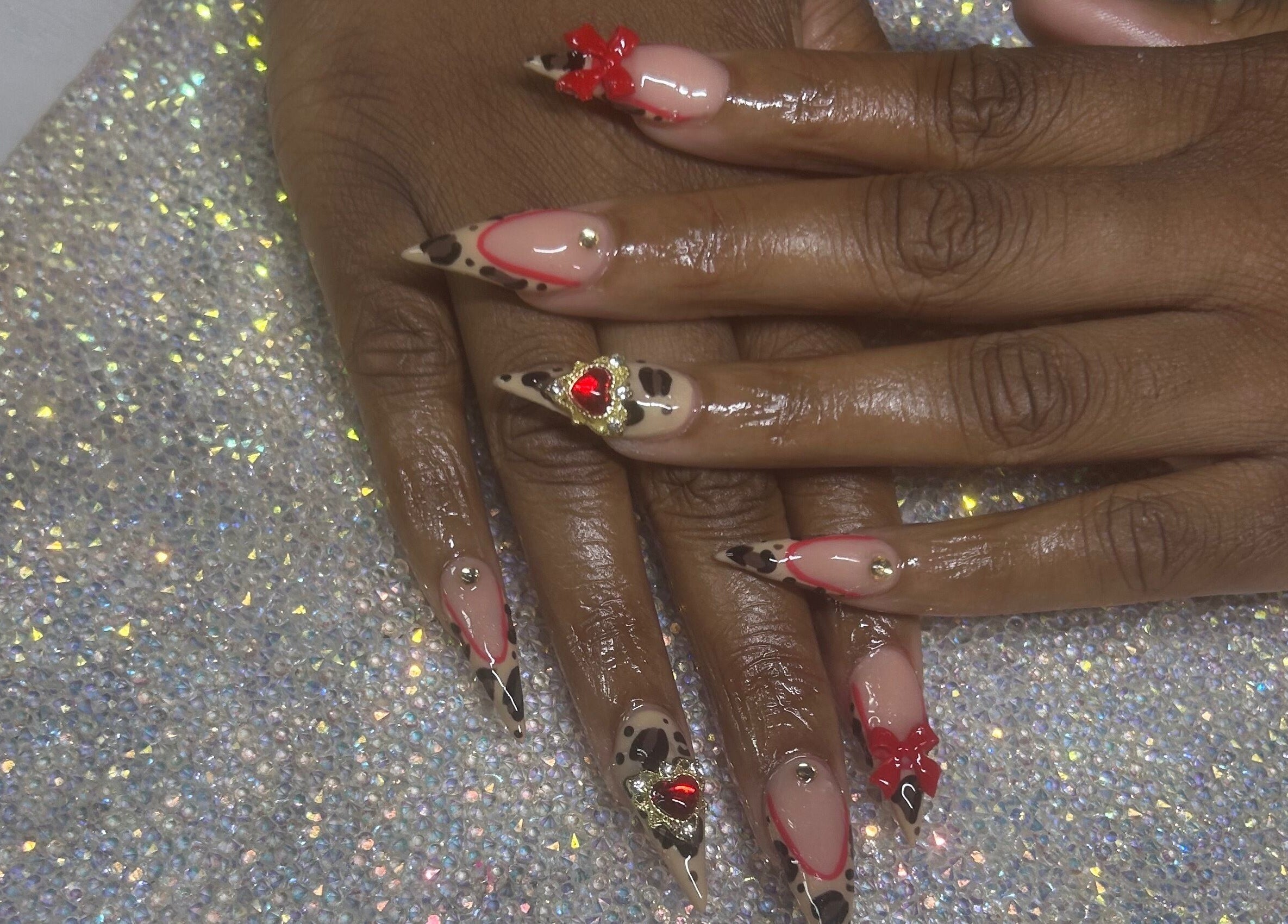 Glamorous nail art with red gems and leopard print by Nails by Haylee, Virginia Beach, Virginia, US.