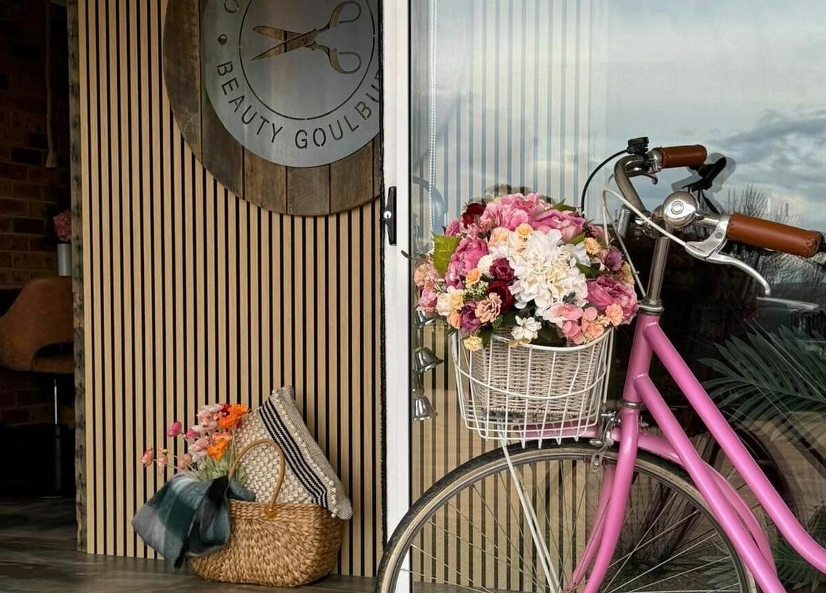 Charming pink bike with flower basket outside Outback Hair & Beauty Goulburn in Goulburn, New South Wales, AU.
