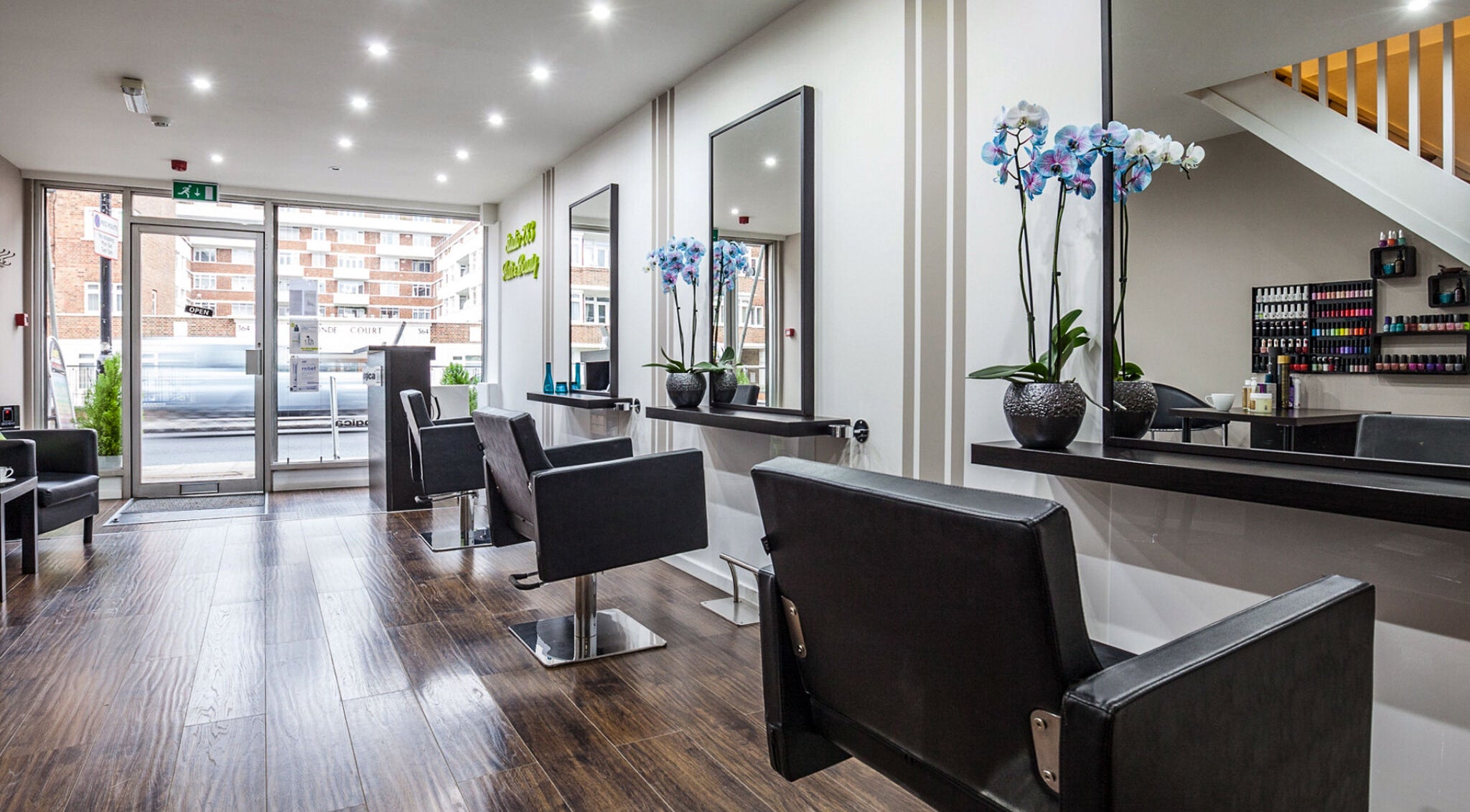Elegant interior of Studio 283 Hair & Beauty in London, England, GB with modern styling chairs and mirrors.