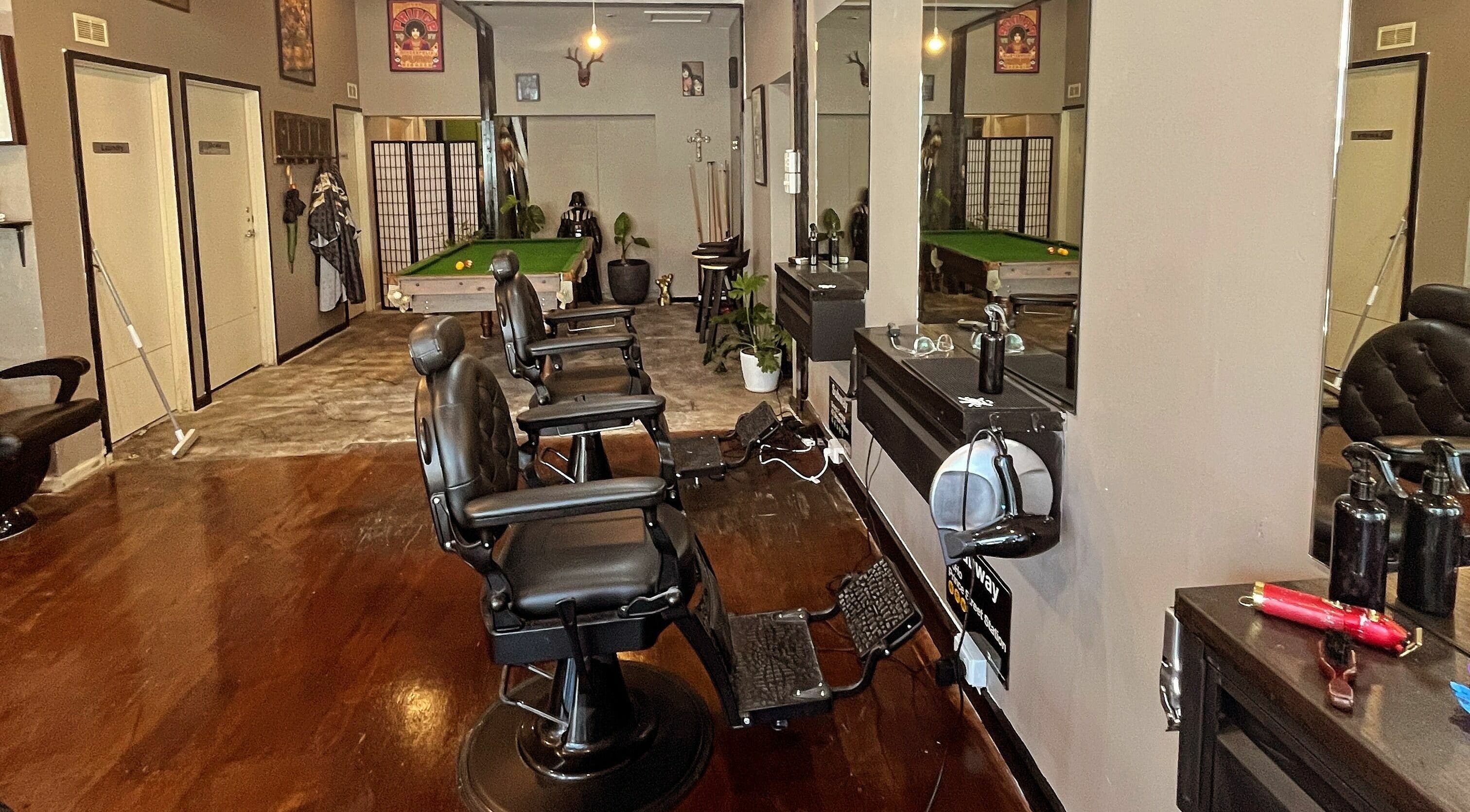 Interior of Chop Chop Barbers in Melbourne, Victoria, AU featuring sleek barber chairs and a pool table.