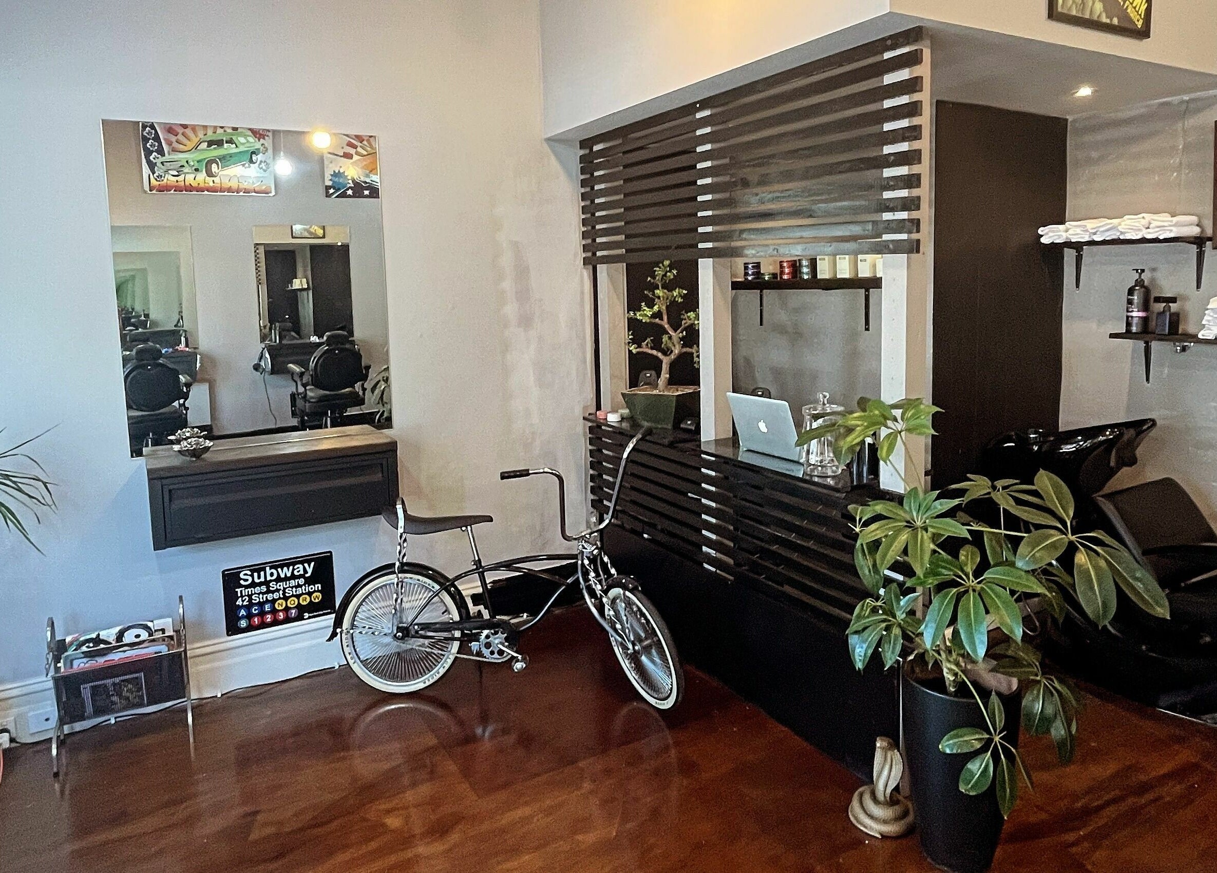 Modern interior of Chop Chop Barbers, Melbourne, Victoria, AU, featuring stylish decor with bicycle and plants.