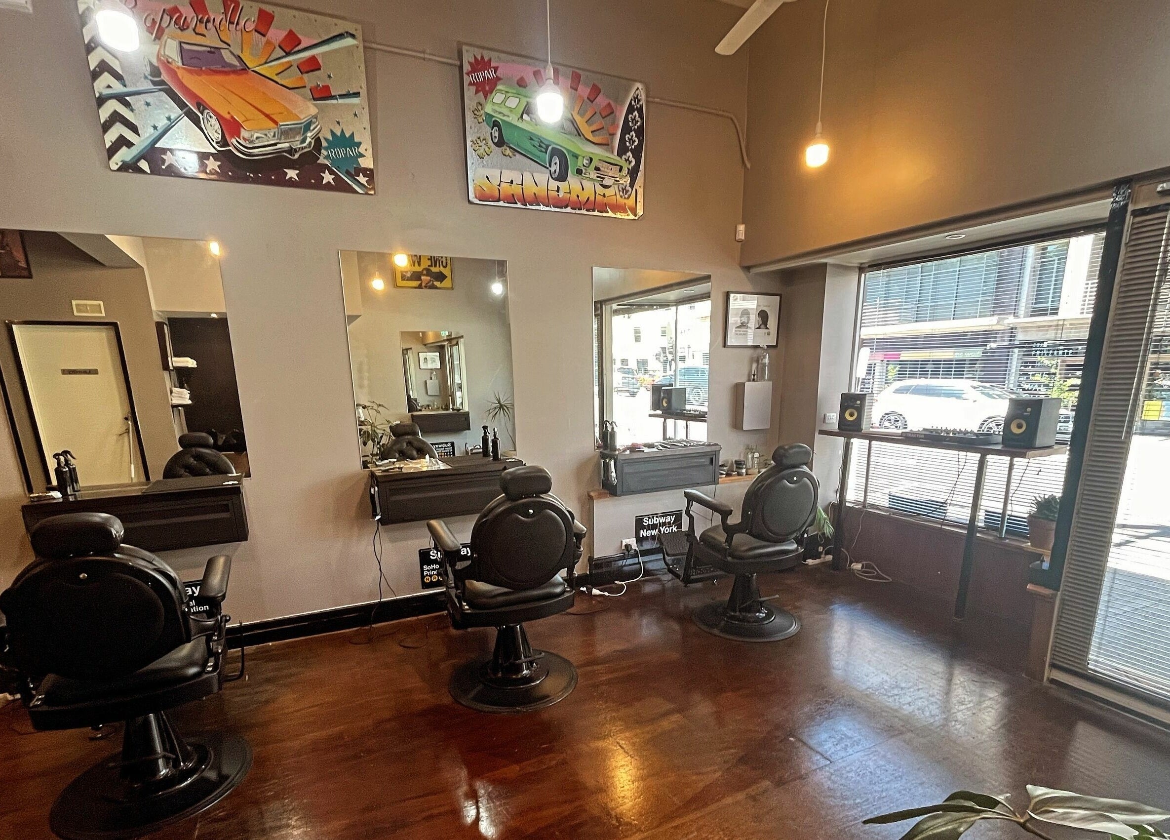 Interior of Chop Chop Barbers in Melbourne, Victoria, AU, featuring stylish barber chairs and retro decor.