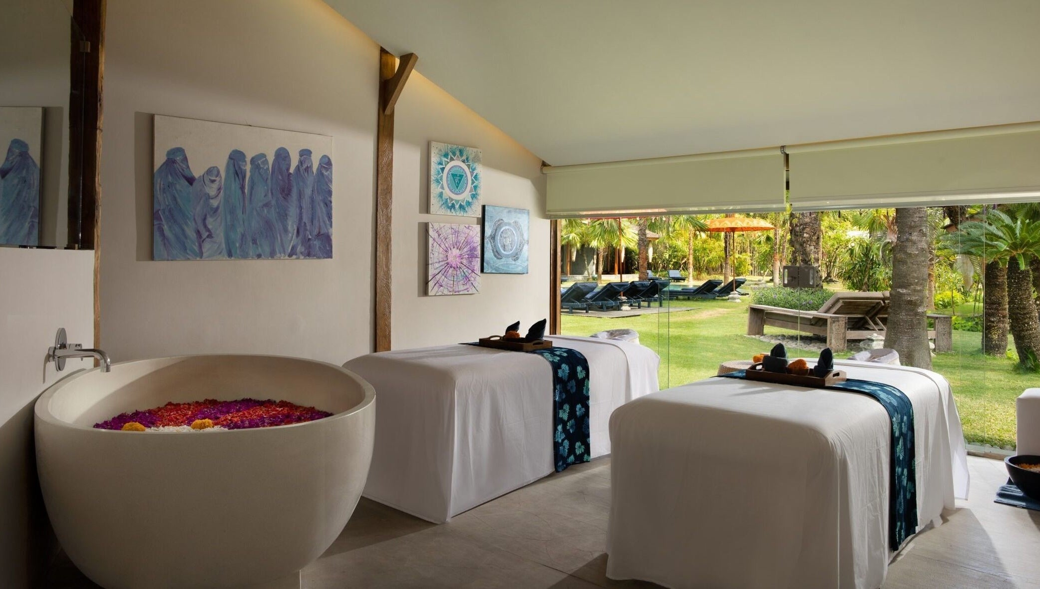 Tranquil treatment room at Heiwa Spa, Bali, Bali, ID with massage tables and garden view.