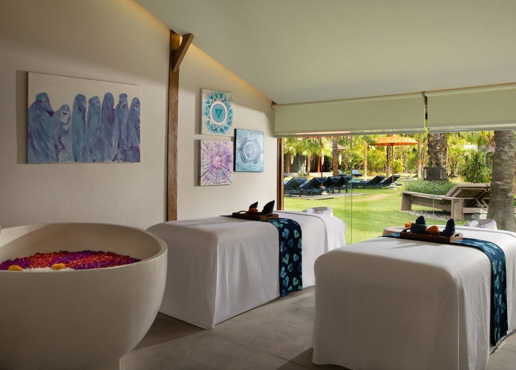 Tranquil treatment room at Heiwa Spa, Bali, Bali, ID with massage tables and garden view.