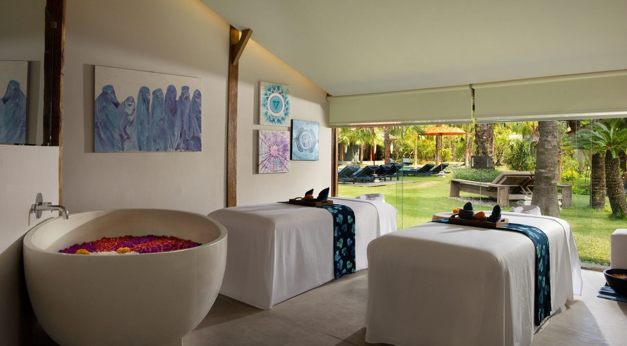 Tranquil treatment room at Heiwa Spa, Bali, Bali, ID with massage tables and garden view.