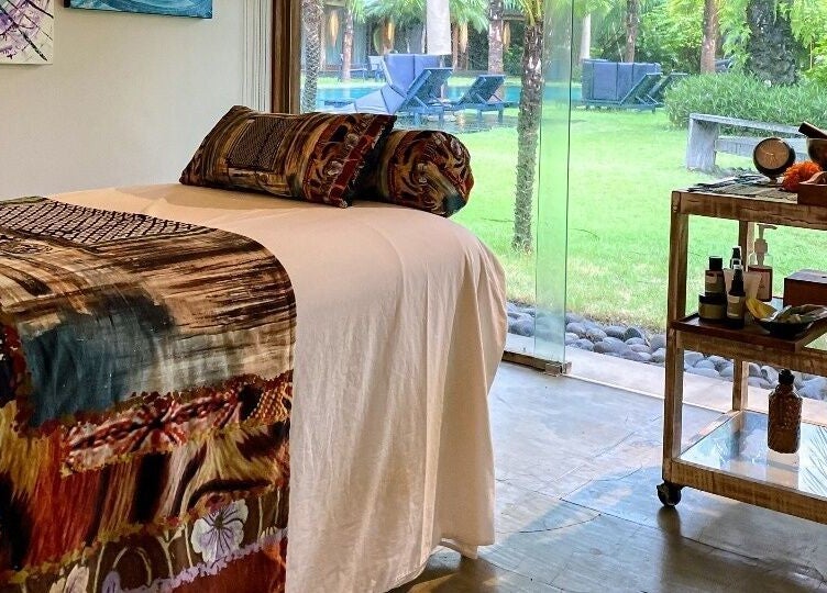 Relaxing massage room at Heiwa Spa with garden view, Bali, Bali, ID. Tranquil and earthy ambiance.