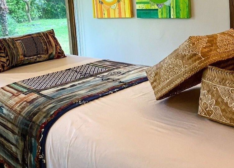 Luxurious massage bed at Heiwa Spa, Bali, Bali, ID, with vibrant bedding and traditional decor.