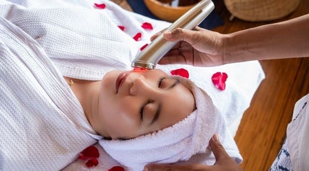 Relaxing facial treatment at Flying Bamboo Spa, Bali, Bali, ID with rose petals and soothing atmosphere.