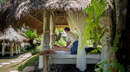 Relaxing outdoor massage at Flying Bamboo Spa, Bali, Bali, ID, showcasing tranquility and natural beauty.