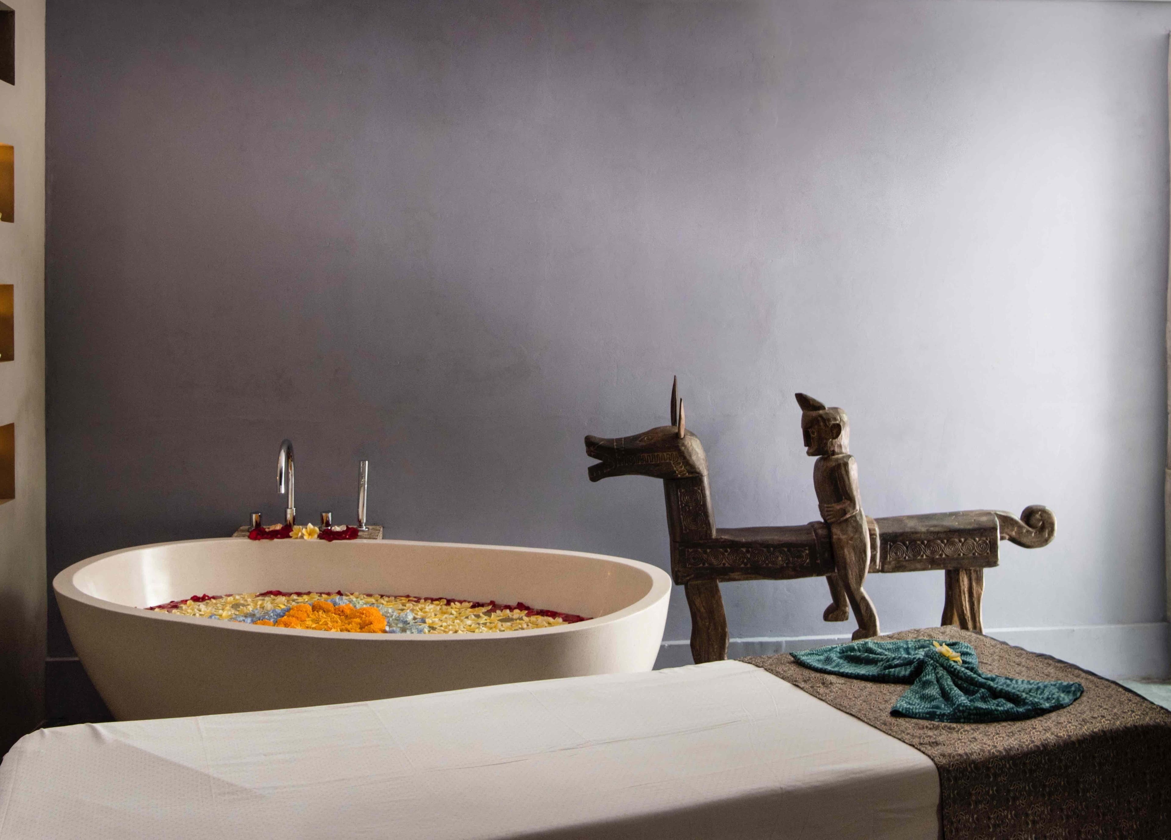 Luxurious bath setup at Mudara Spa in Bali, Bali, ID, with floral accents and unique decor.