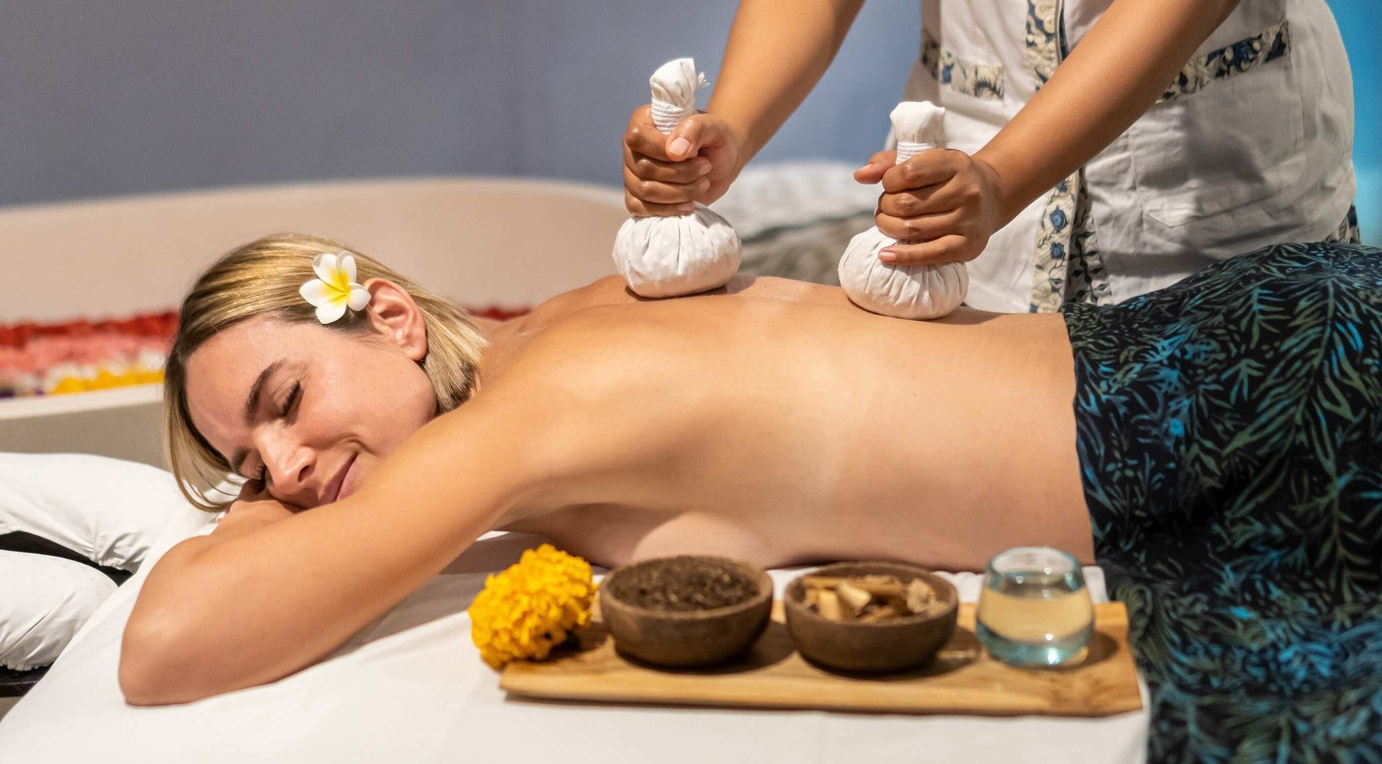 Relaxing massage at Mudara Spa in Bali, Bali, ID with herbal compress therapy, enhancing wellness experience.