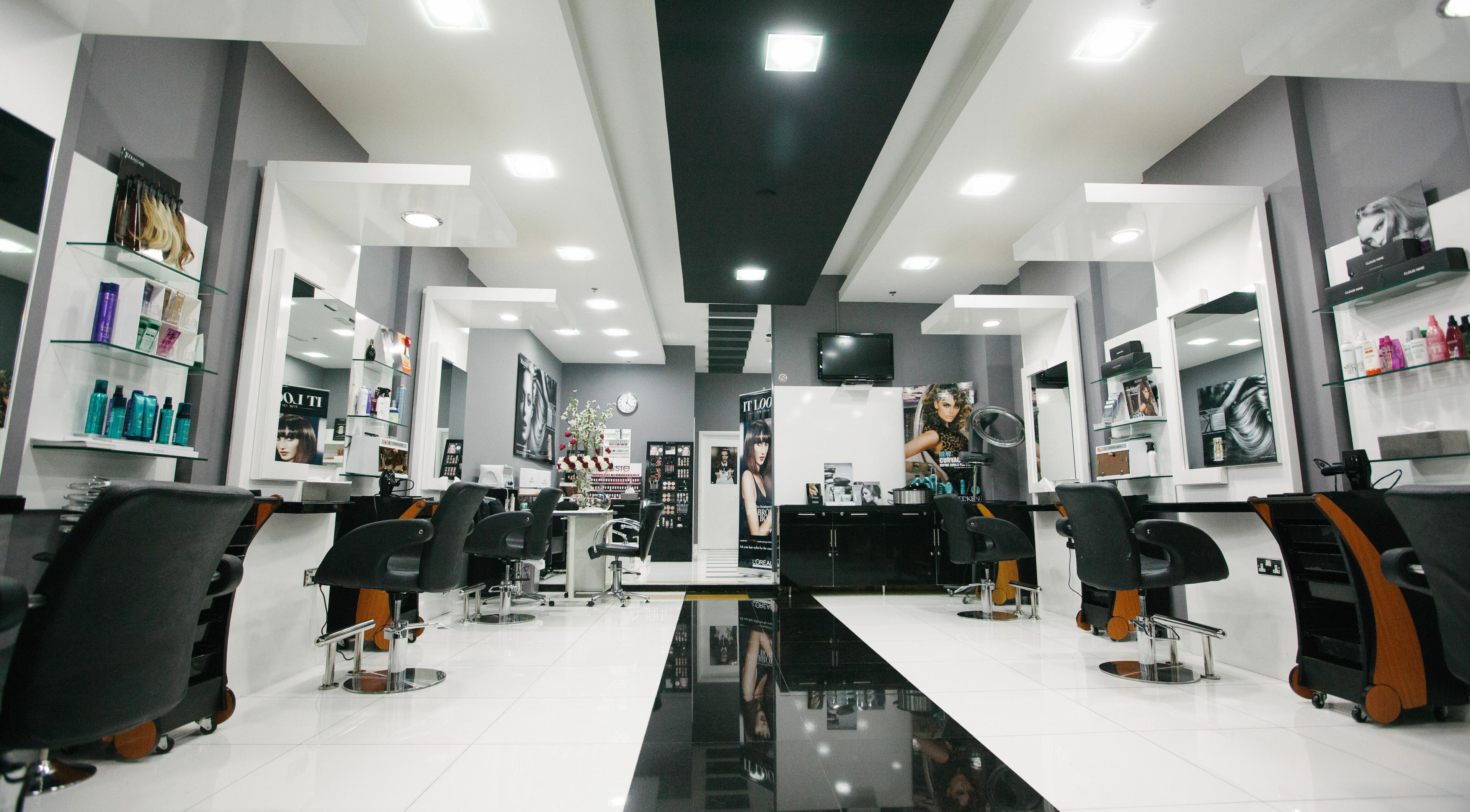 Modern interior of Roots Beauty Salon - Etihad Mall in Dubai, AE with sleek styling stations and vibrant decor.