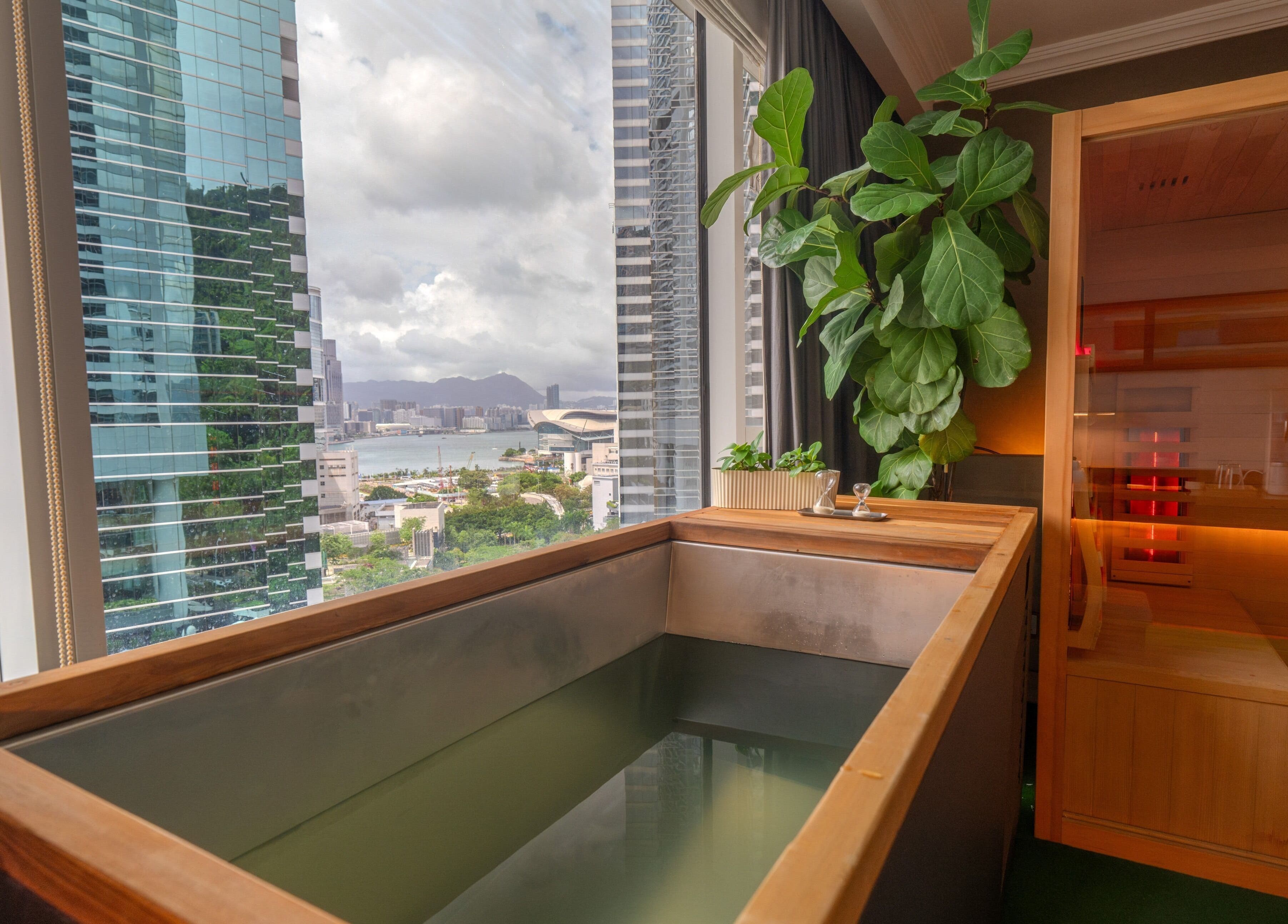 Luxury wellness retreat at 10x Longevity on Hong Kong Island, featuring a scenic city view and sauna.