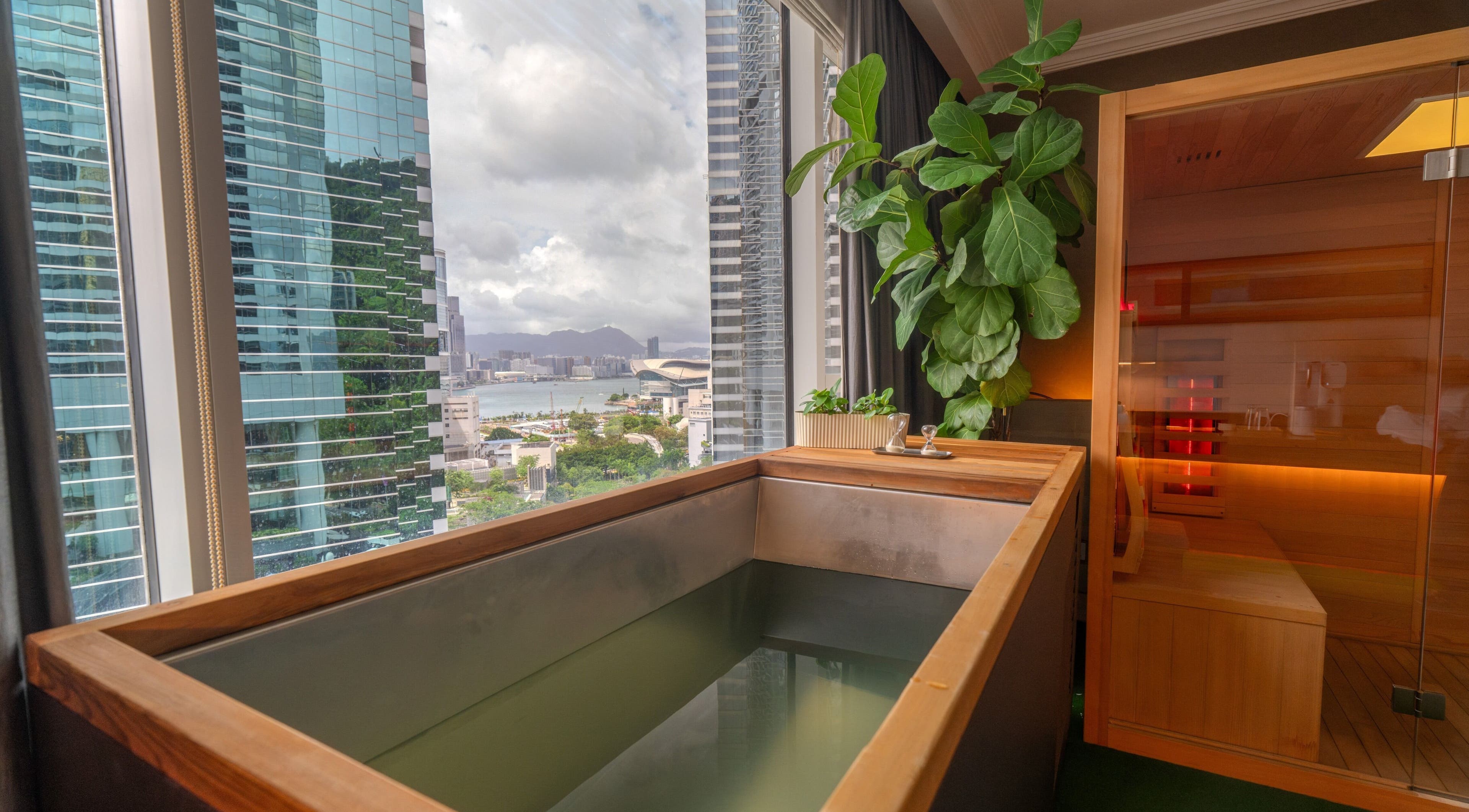 Luxury wellness retreat at 10x Longevity on Hong Kong Island, featuring a scenic city view and sauna.