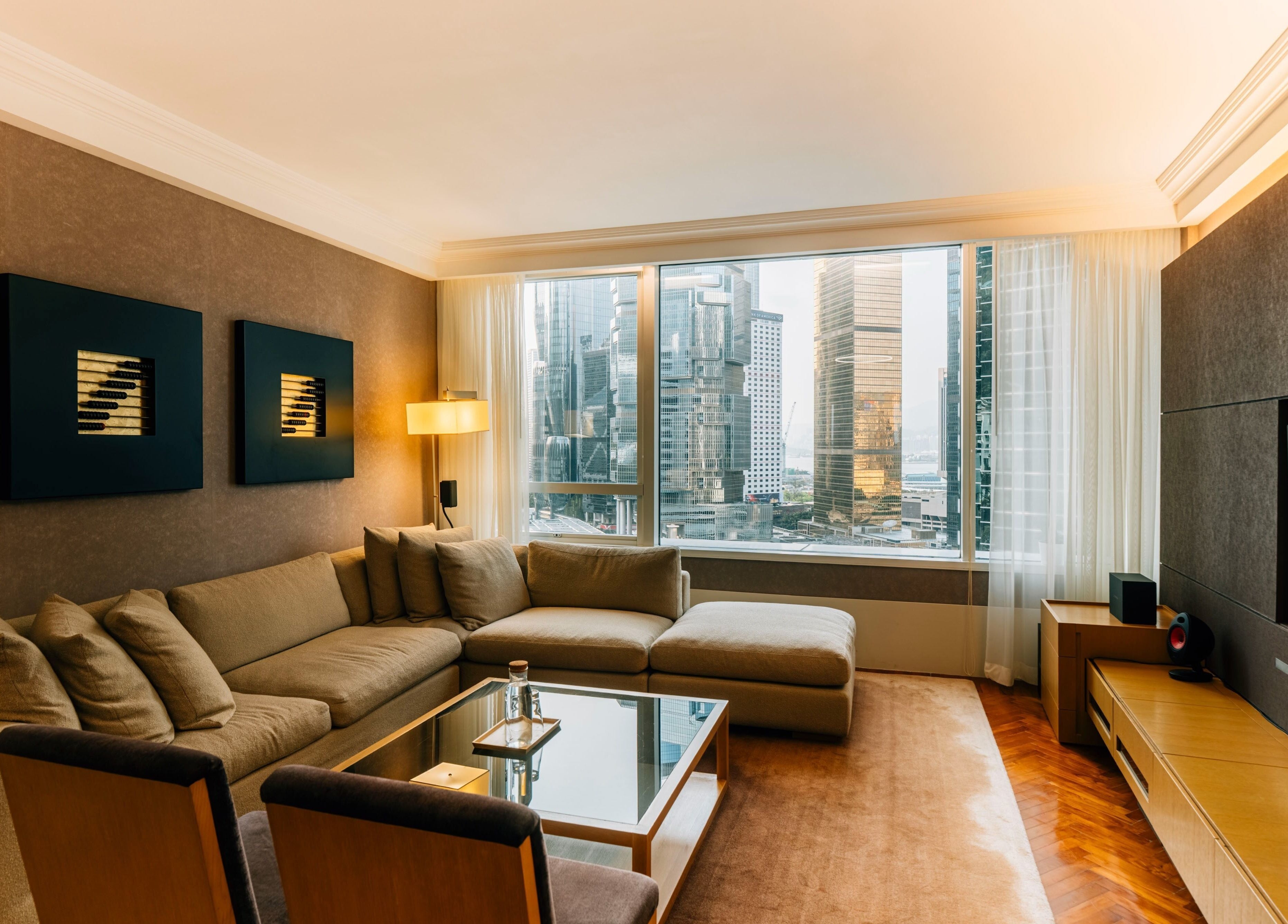 Spacious lounge at 10x Longevity on Hong Kong Island, featuring cozy seating with cityscape views.