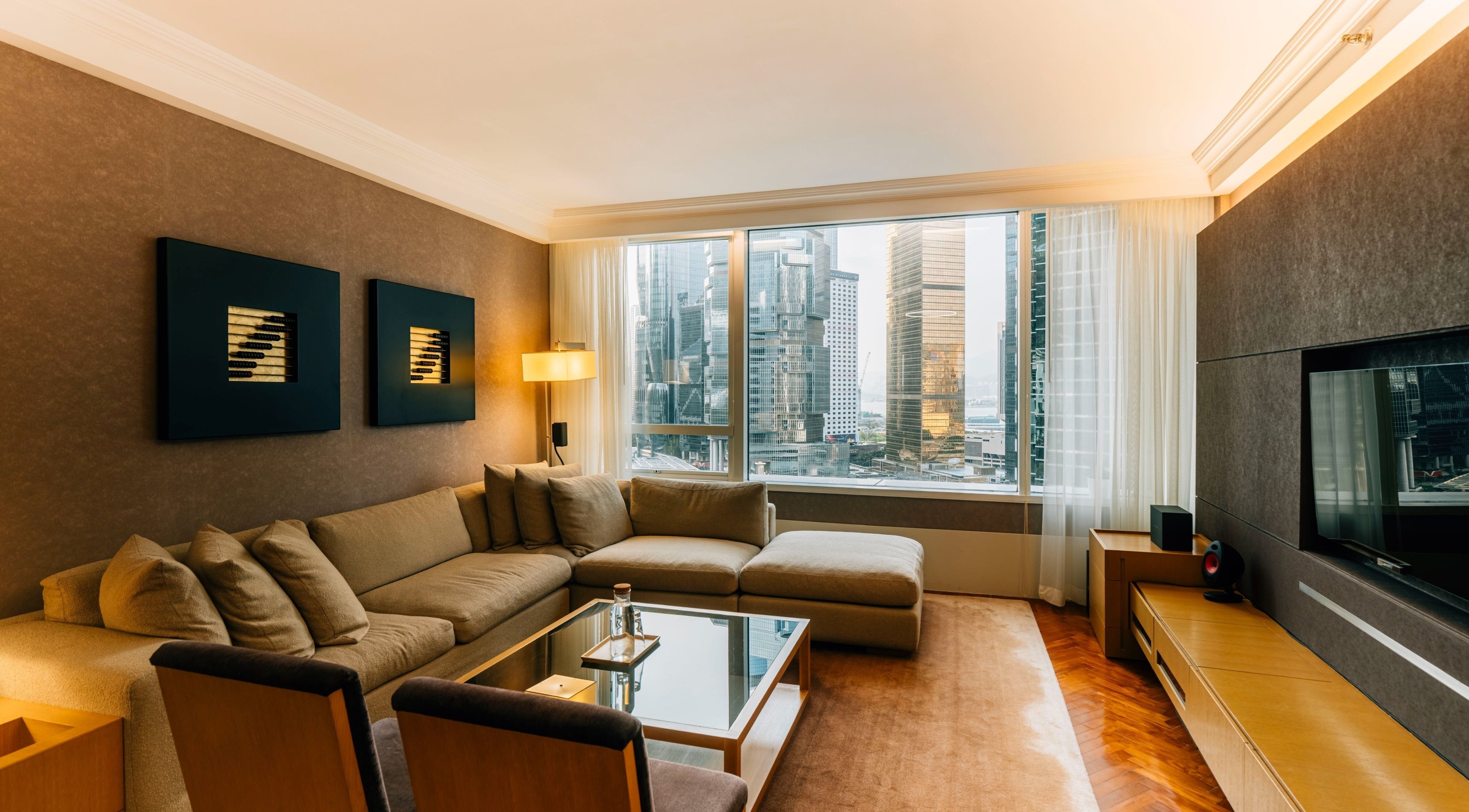 Spacious lounge at 10x Longevity on Hong Kong Island, featuring cozy seating with cityscape views.