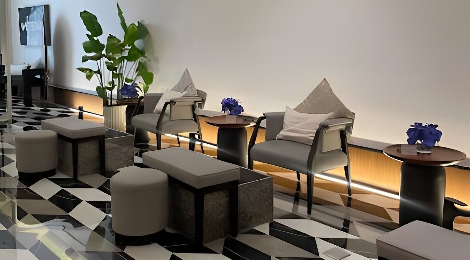 Elegant seating area at Whitetail Nail Spa, Riyadh, Riyadh Province, SA, featuring modern chairs and lush plants.