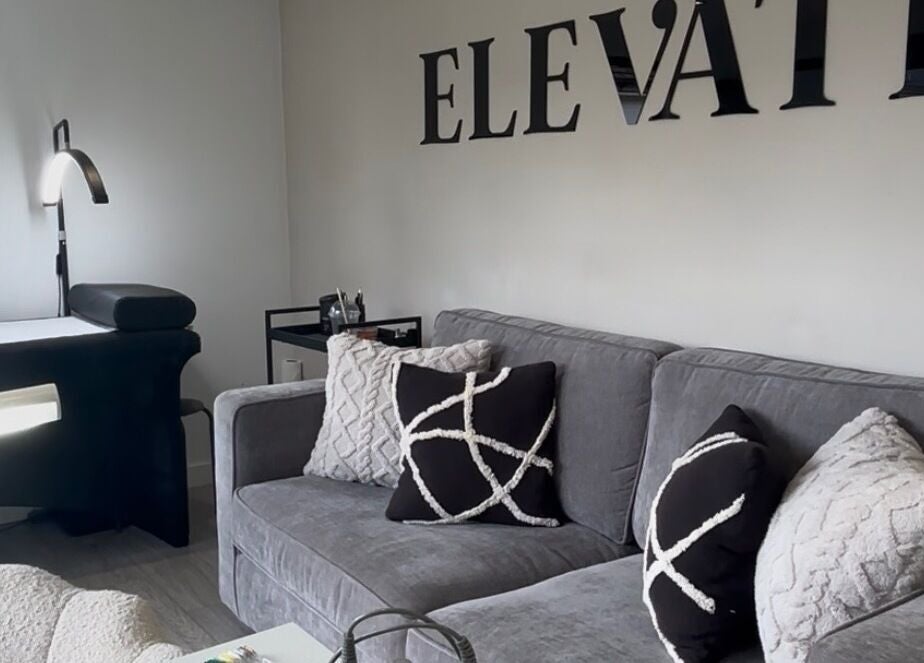 Modern lash studio at Elevate Lashes, Berkhamsted, England, GB, featuring a cozy seating area and treatment bed.