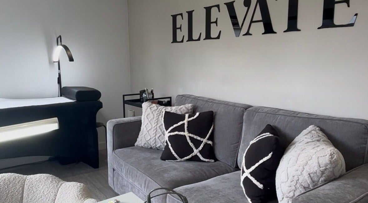 Modern lash studio at Elevate Lashes, Berkhamsted, England, GB, featuring a cozy seating area and treatment bed.