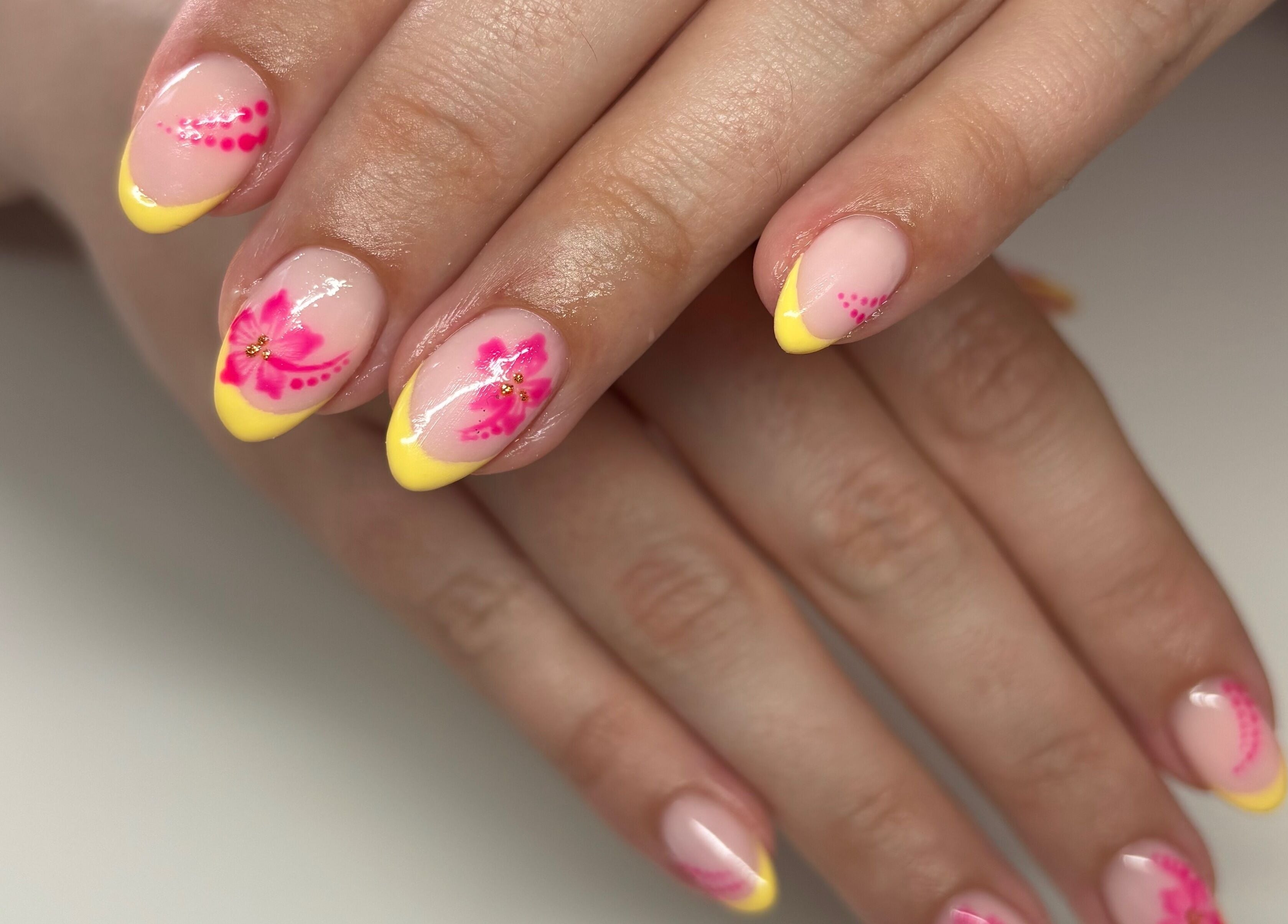 Pink floral nail art with yellow tips at Elevate Lashes, Berkhamsted, England, GB.
