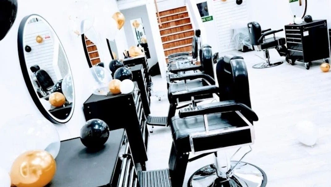 Interior of So Fresh Afro Barber in Bolton, England, GB showcasing modern chairs and vibrant balloon decor.