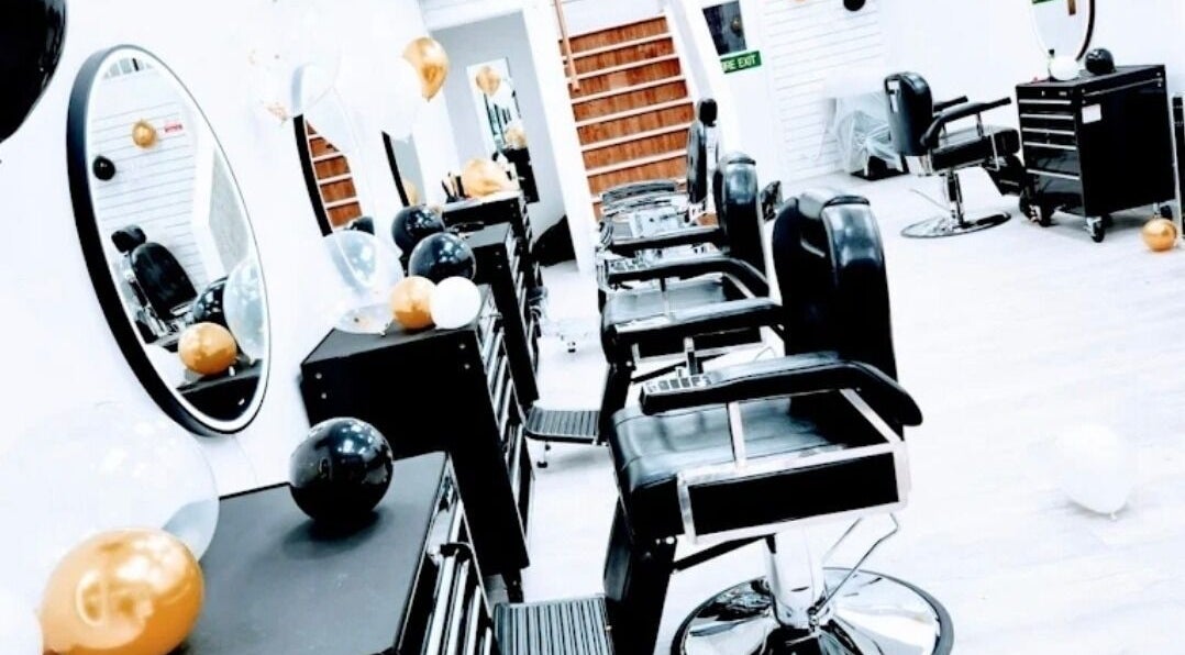 Interior of So Fresh Afro Barber in Bolton, England, GB showcasing modern chairs and vibrant balloon decor.