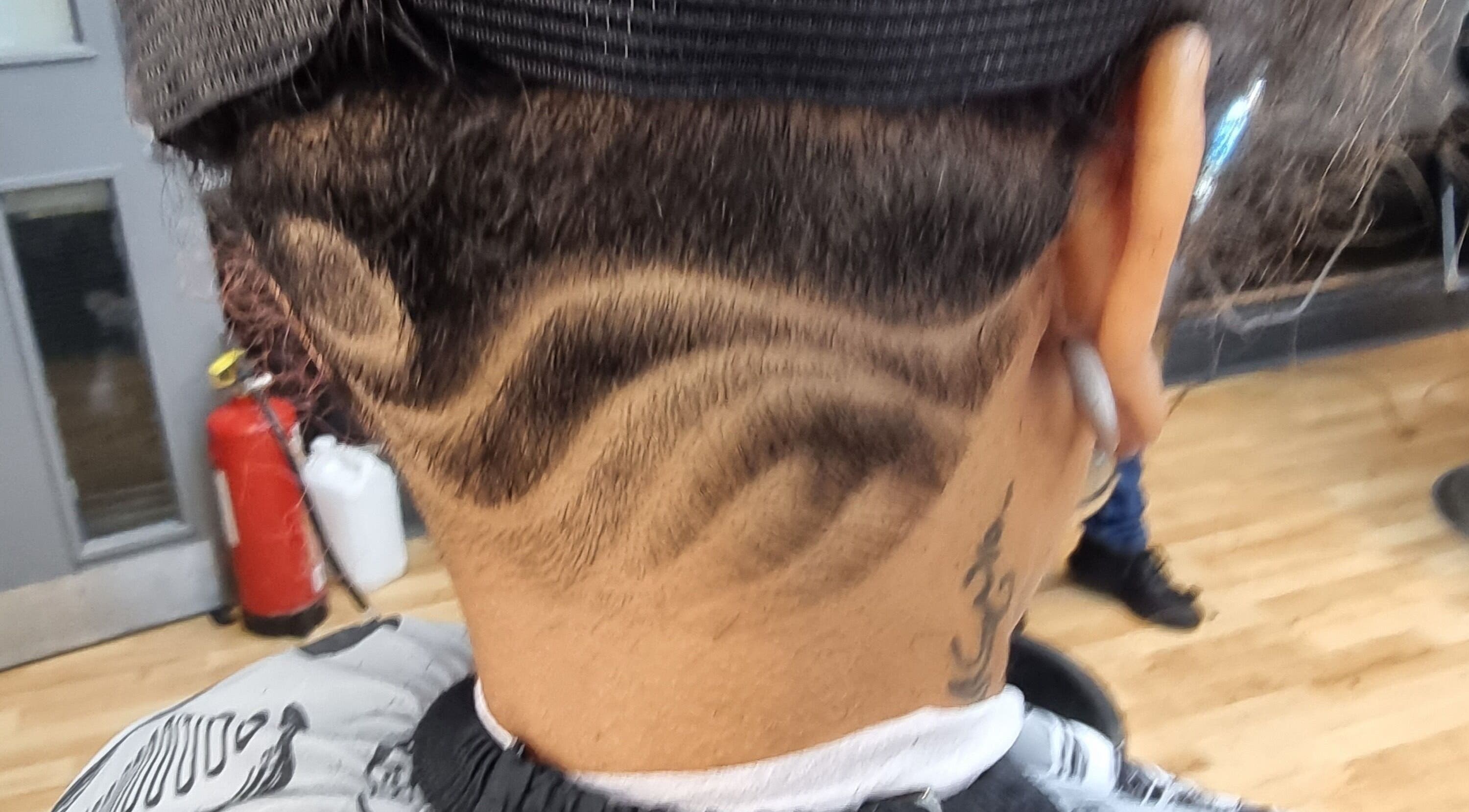 Creative hair design at So Fresh Afro Barber in Bolton, England, GB showcasing intricate patterns.