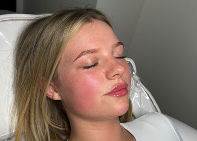 Relaxed client receiving facial at LUMI AESTHETICS, Pudsey, England, GB, for radiant skin rejuvenation.