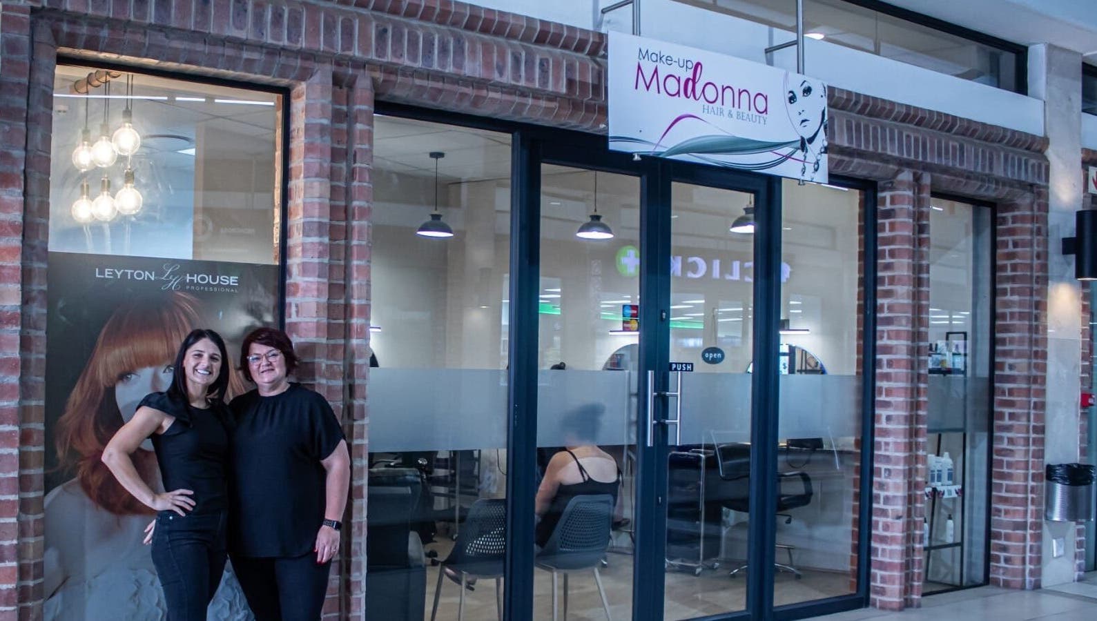 Ilze at Makeup Madonna's elegant entrance in Wellington, Western Cape, ZA with staff welcoming visitors.